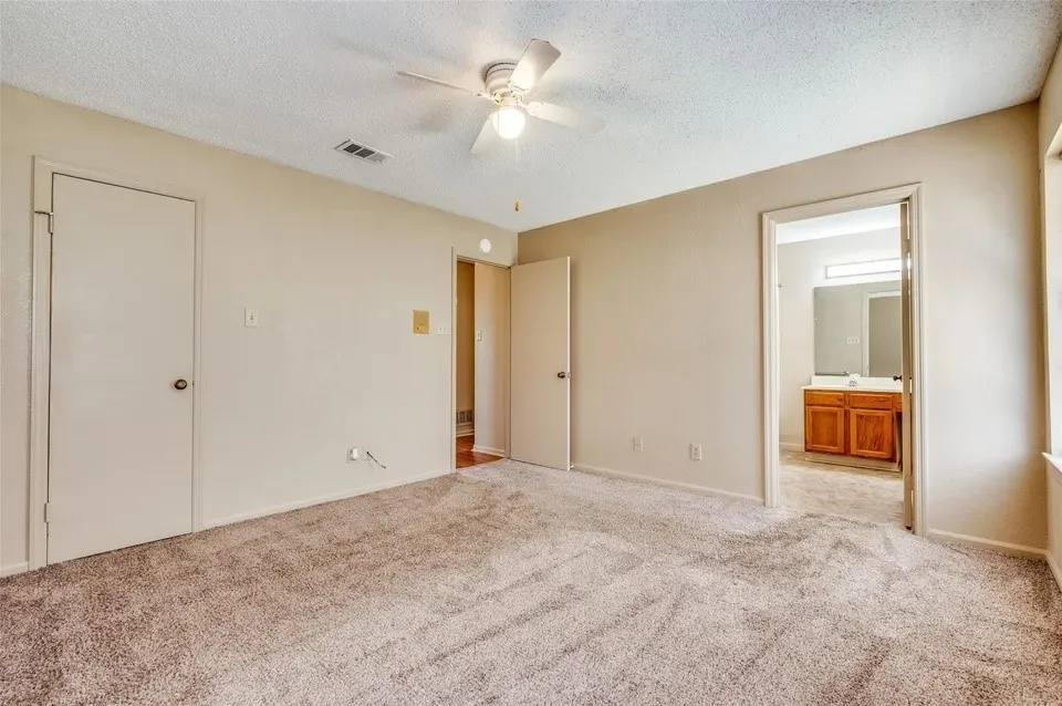 Neutral-toned carpeting throughout, ceiling fan with integrated lighting, and a neutral wall palette