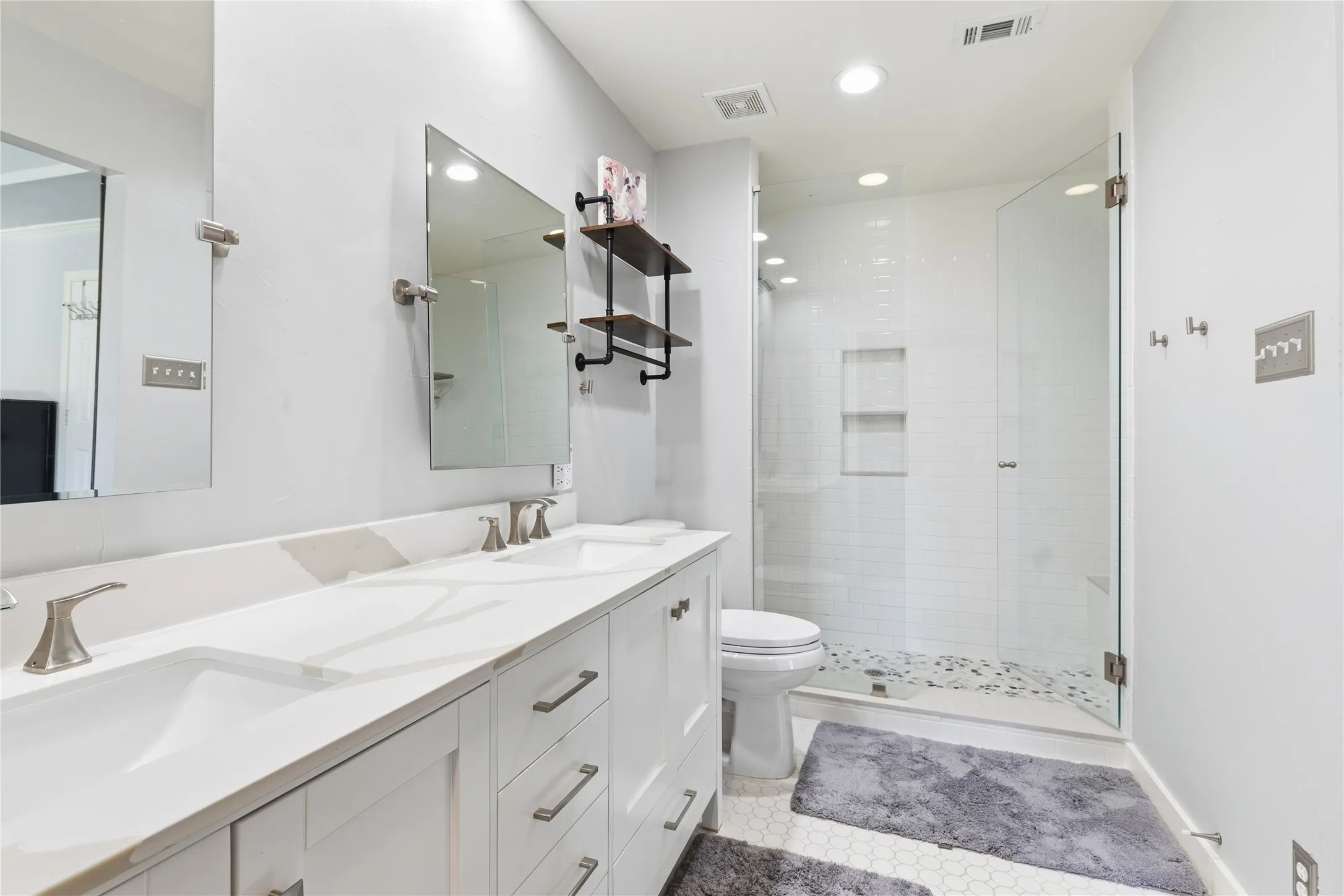 Dual vanity with integrated sinks, quartz countertop, and brushed nickel fixtures