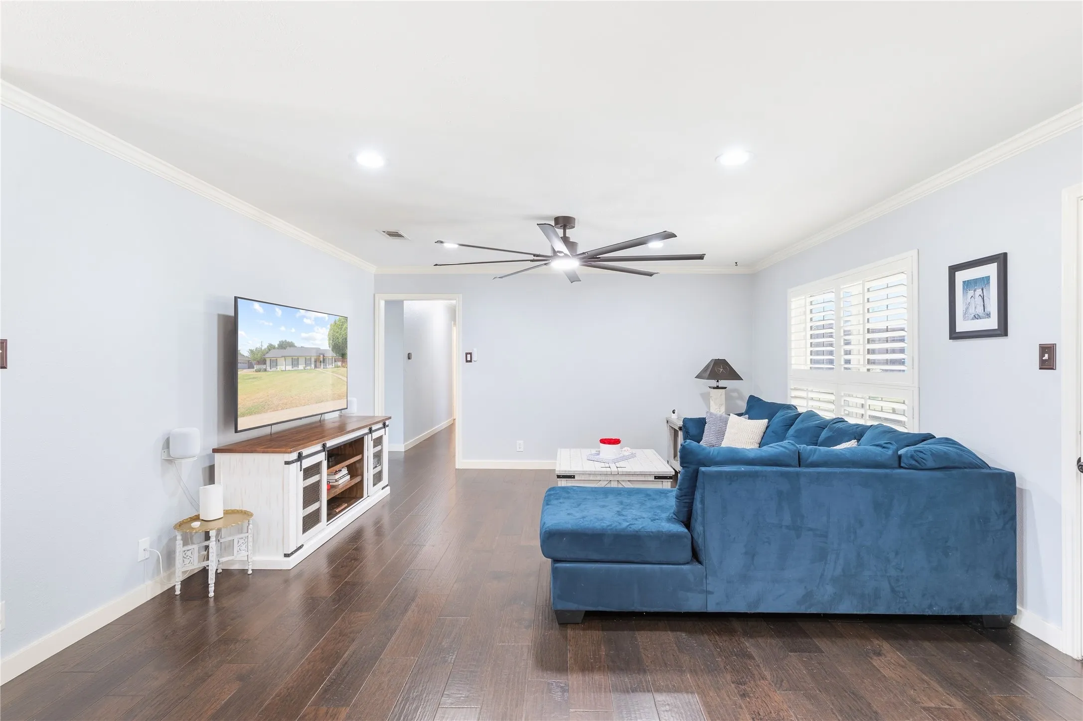 Recessed lighting, crown molding, wood-finish flooring, ceiling fan, and plantation shutters