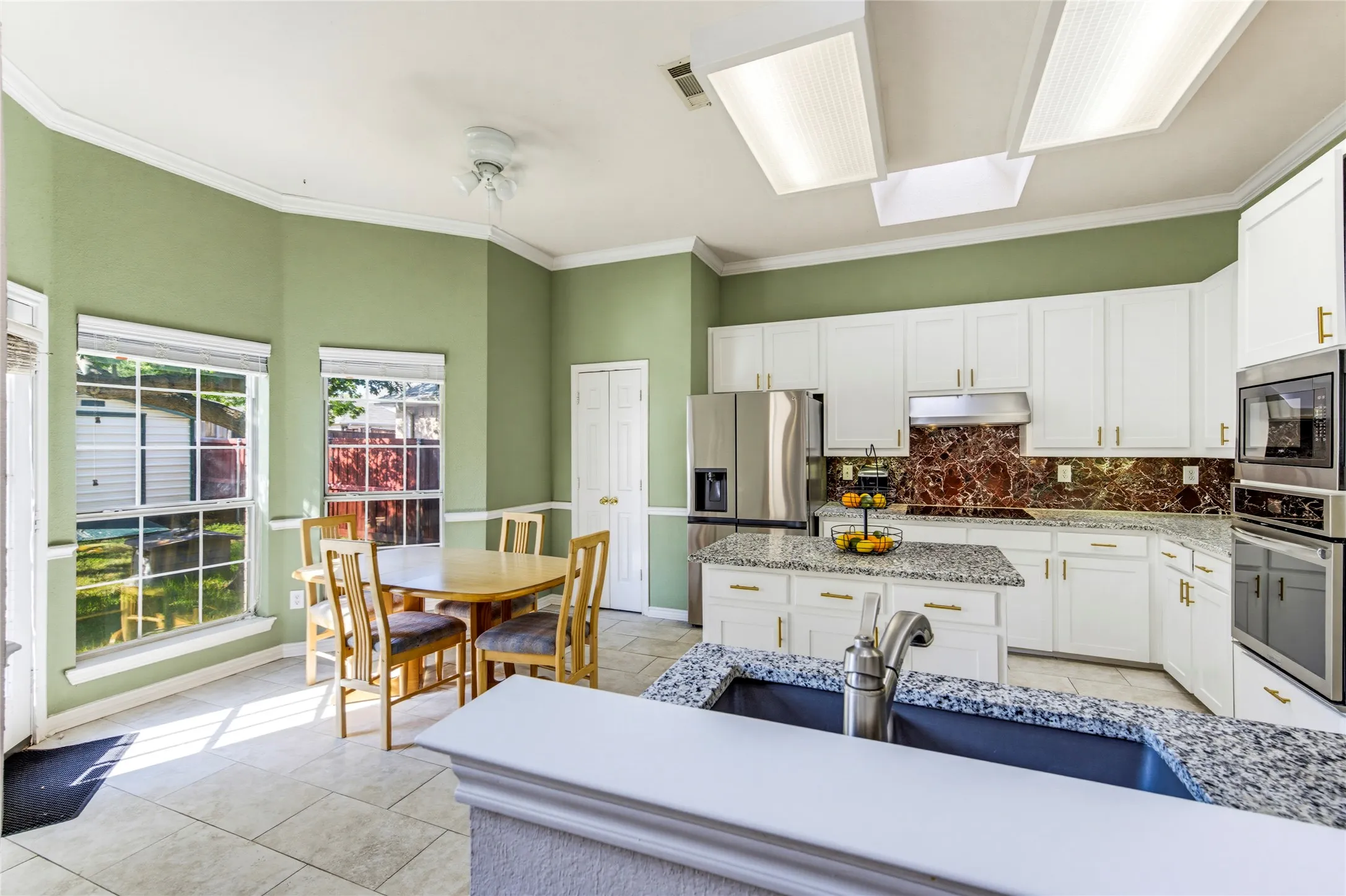 Lots of natural light with the skylight and windows, but still, bright additional lighting in this lovely kitchen...