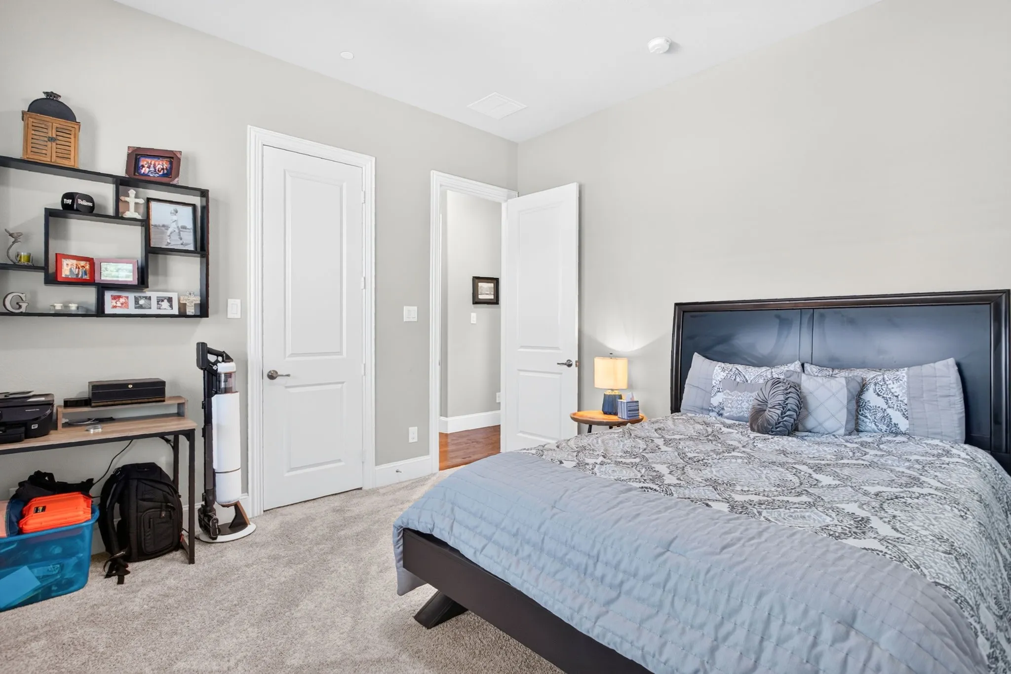 Plush carpeting in a neutral tone, crisp white walls, and a recessed ceiling light