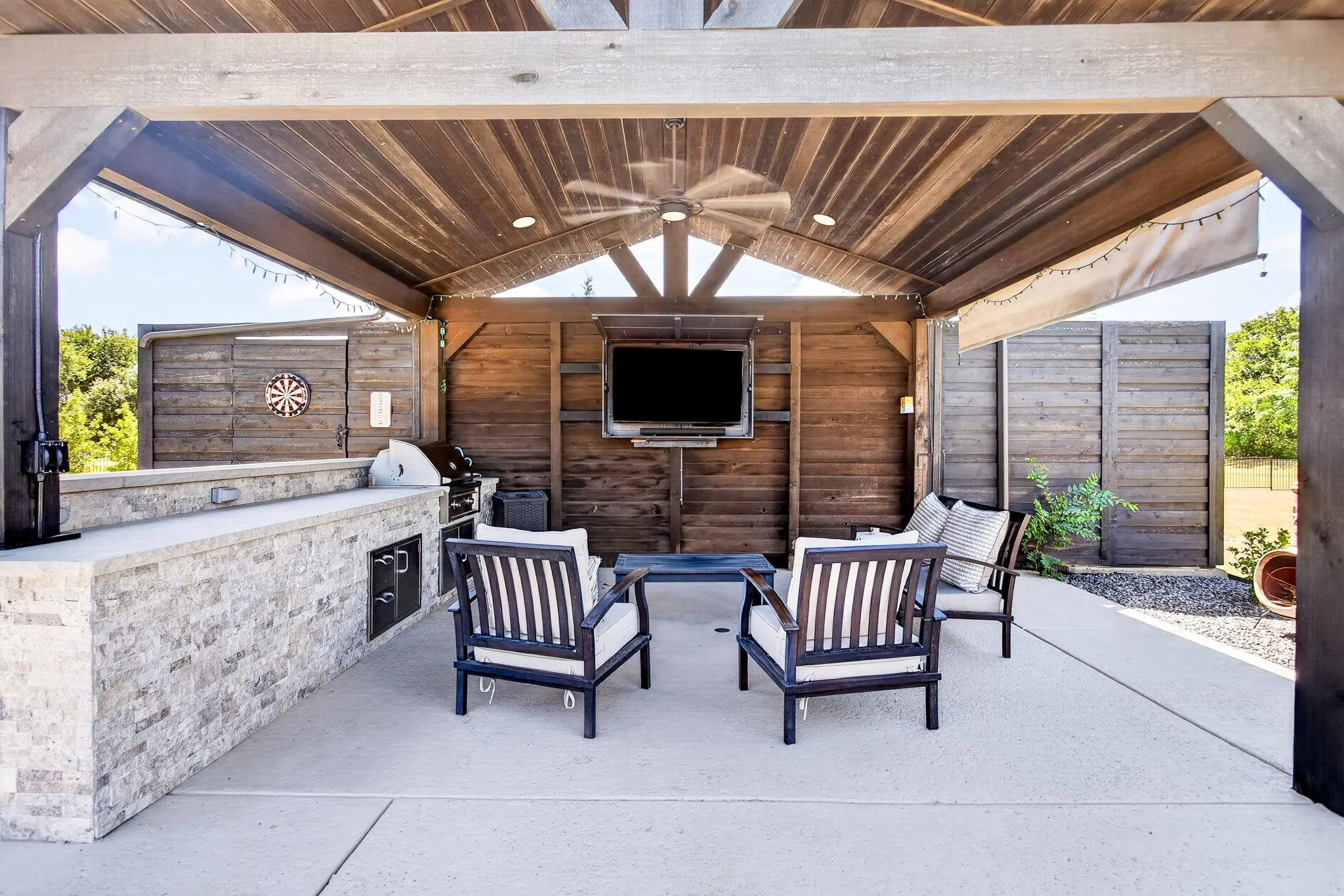 Covered patio featuring a wood-plank ceiling, ceiling fan, and recessed lighting