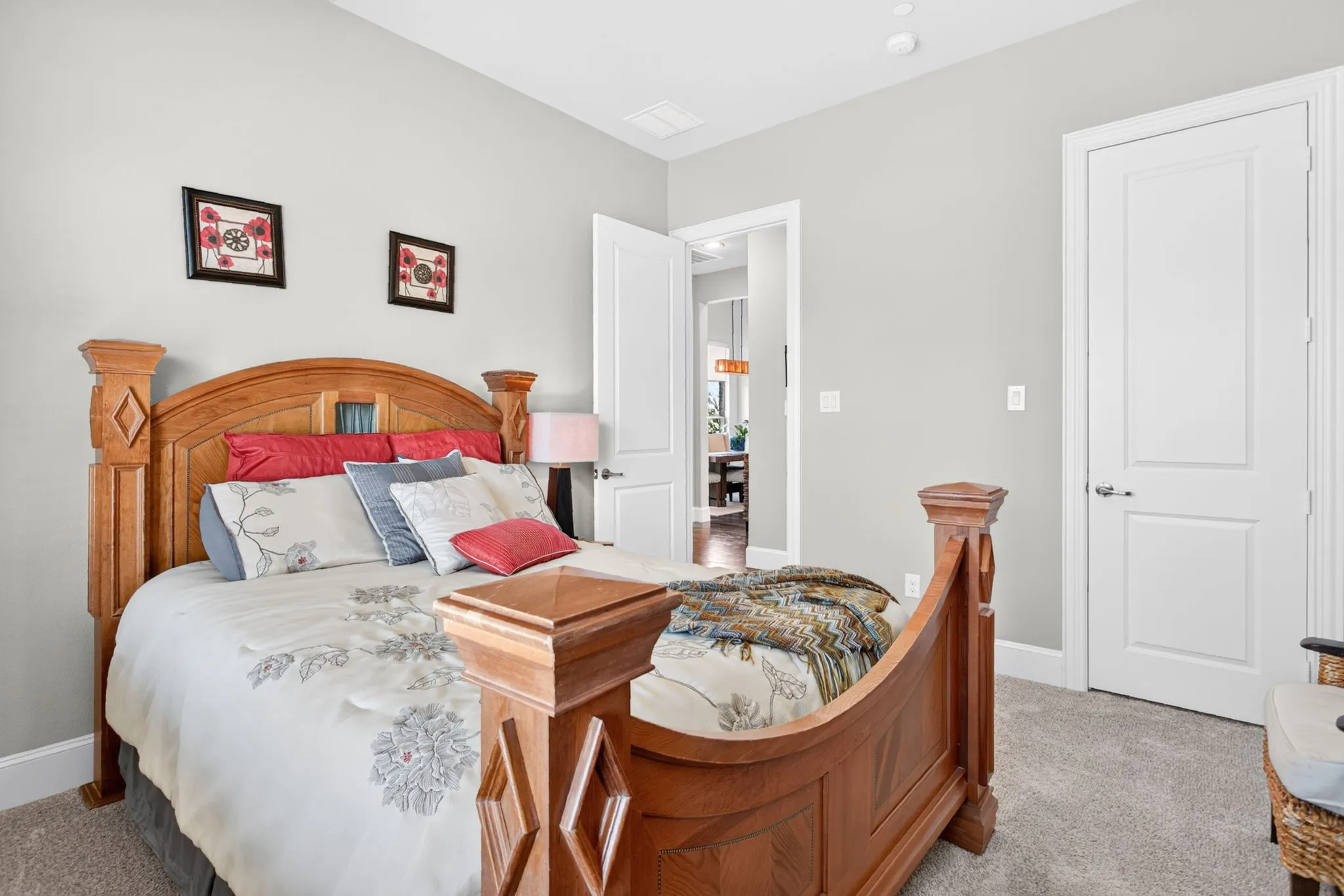 Recessed lighting, light gray wall paint, and gray carpeted flooring