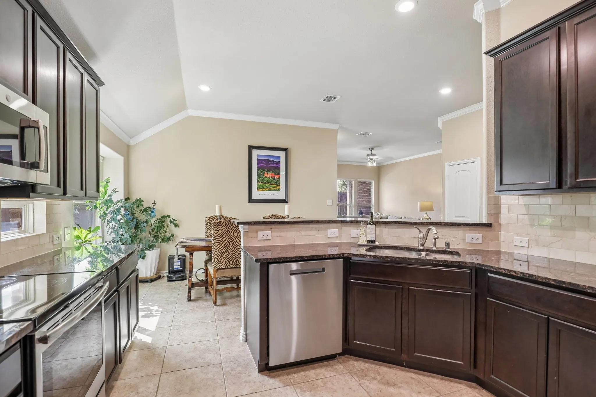 Kitchen features rich wood cabinetry and granite countertops.
