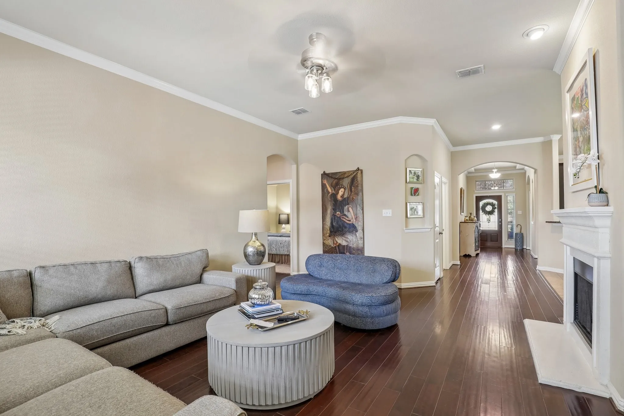Living room with crown molding and cozy fireplace.