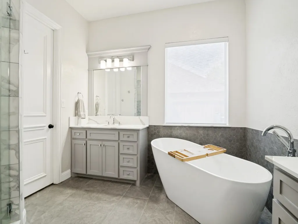 Second vanity in the primary bath with a soaking tub and walk-in closet.