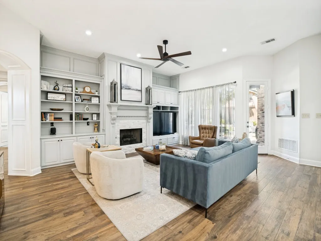 Gorgeous tile flooring, fireplace, recessed lighting, built-ins and decorator fan grace the living room.