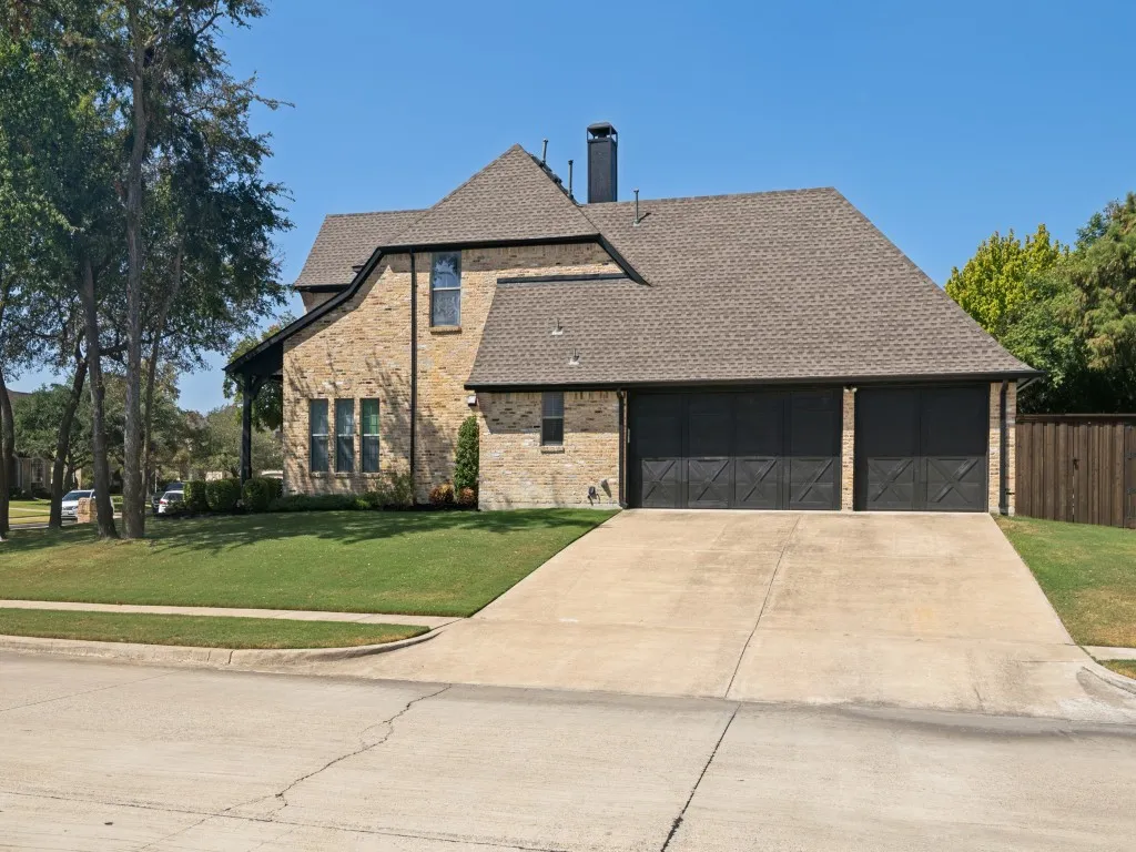 3-car garage with extra parking in the wide driveway.