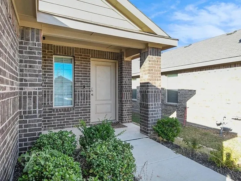 Brick exterior with an inviting covered porch