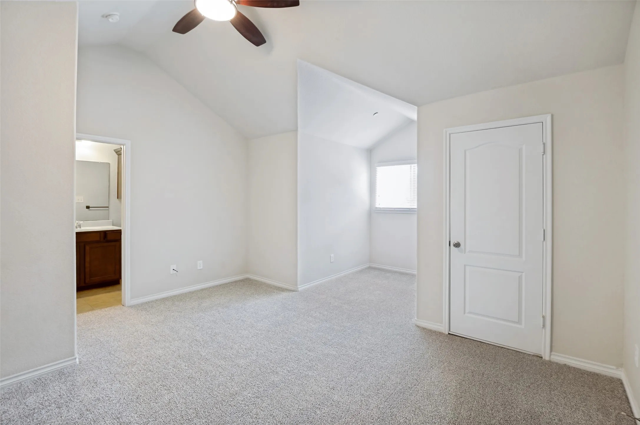 Large 2nd bedroom with vaulted ceiling with a ceiling fan, light gray carpeting, and a window with blinds
