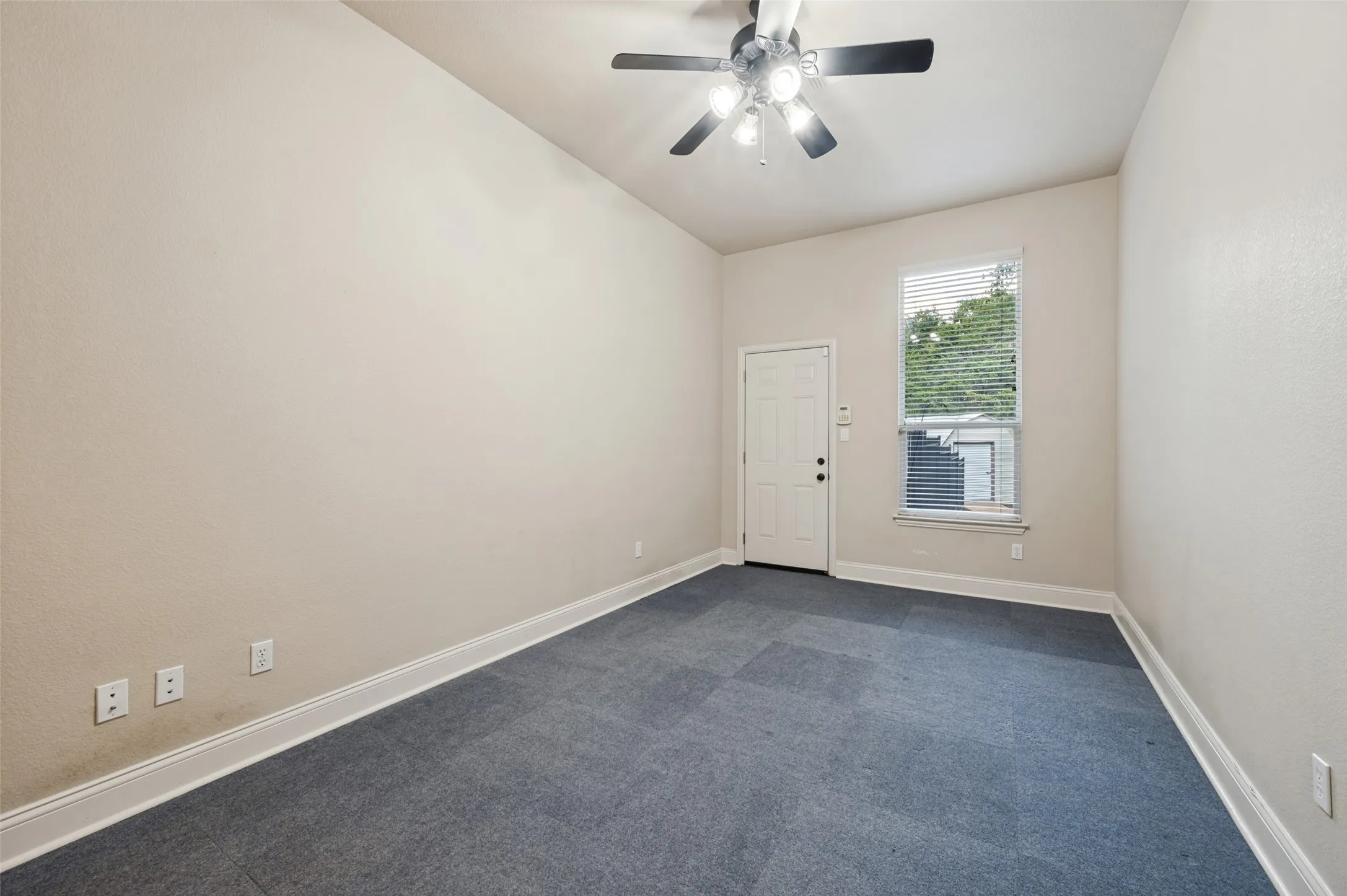 Office space or 4th bedroom - this room features a ceiling fan, it's own exterior door and a massive walk in closet!