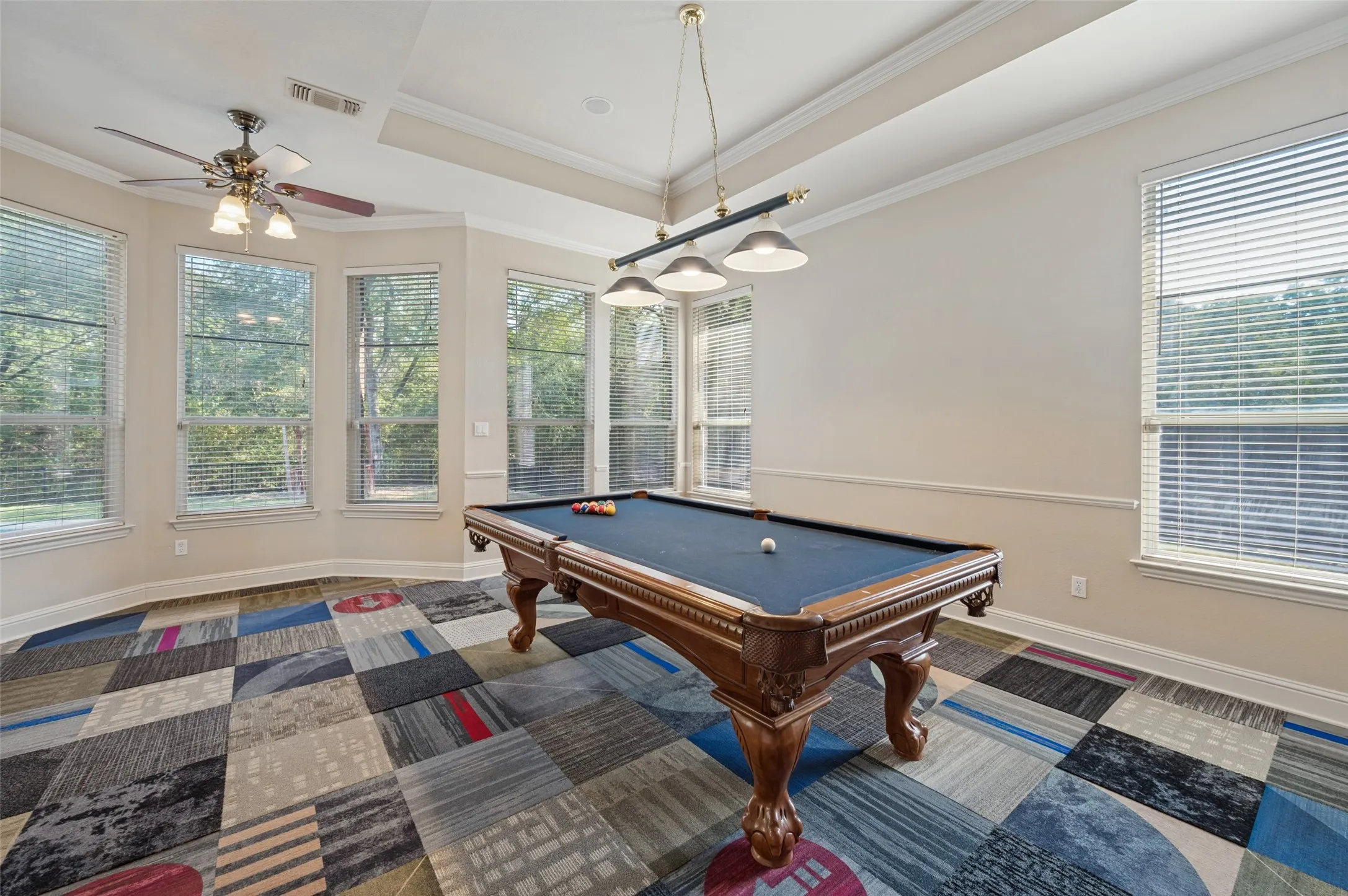 Game room also looks out to the expansive back yard and features a fun pub style lighting fixture.