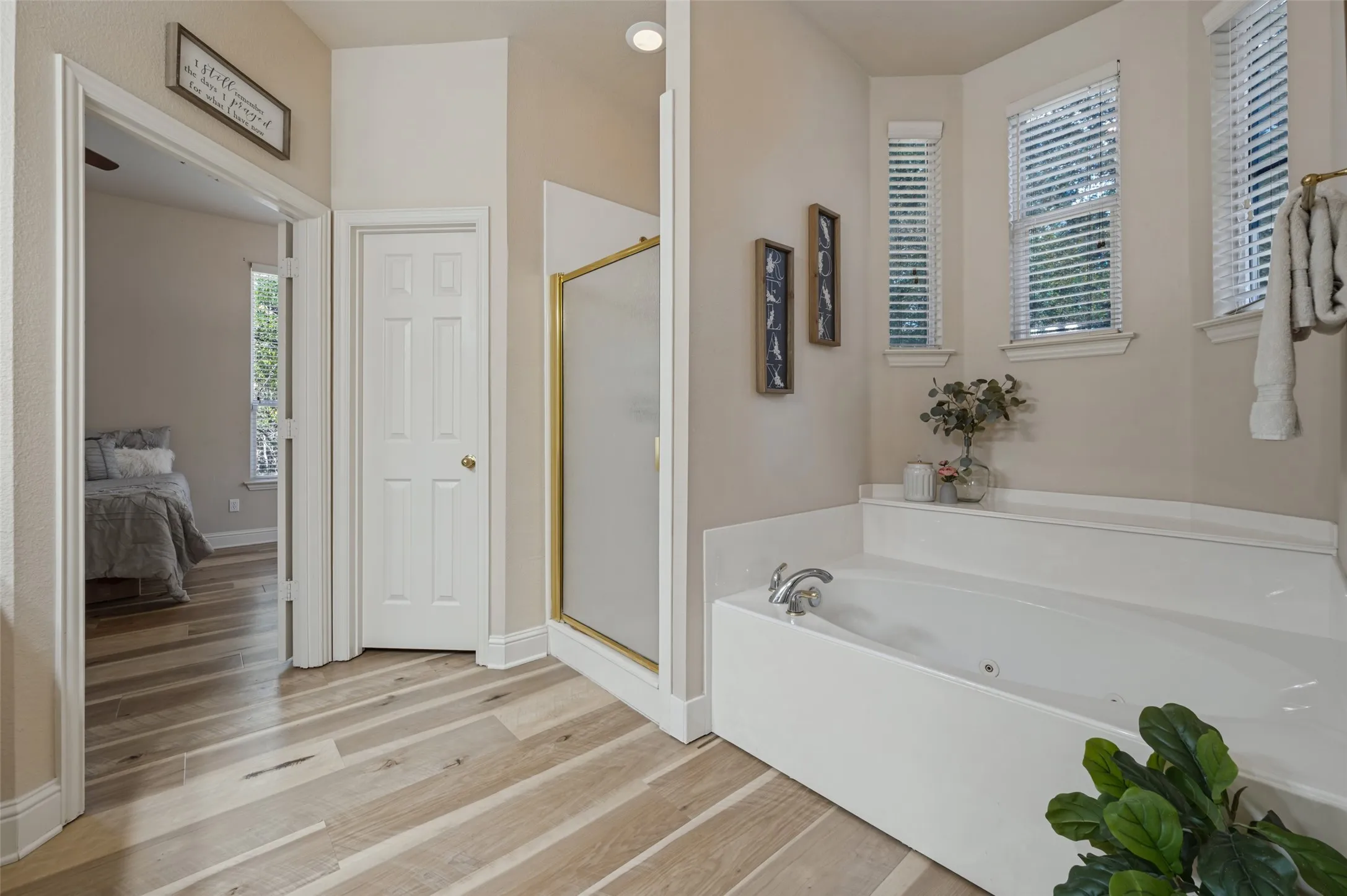 These cute bay windows in the primary bathroom flood the space with natural light and add an elegant touch to this oversized primary bathroom!