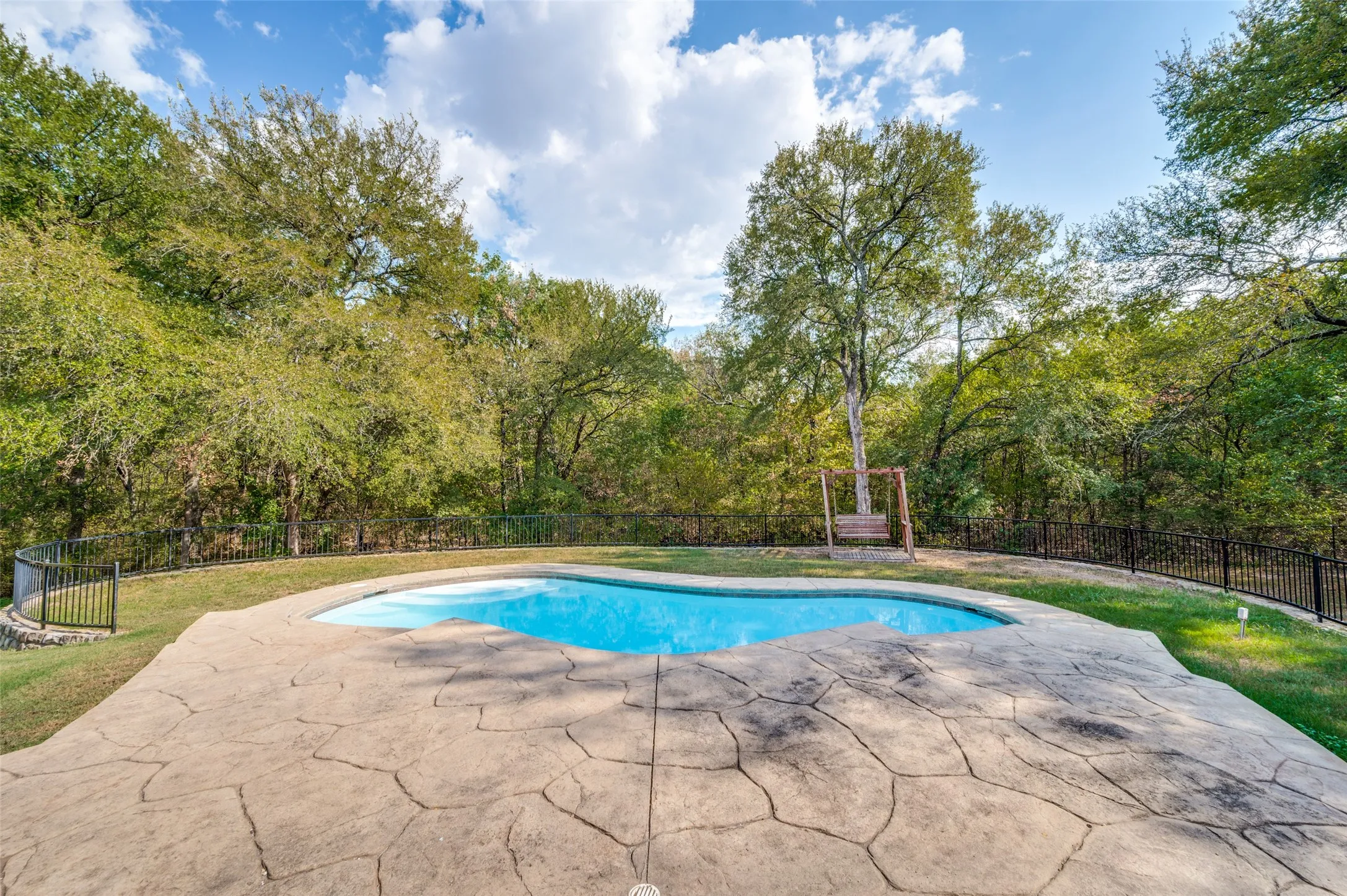 Large deck with endless possibilities over looks the sparkling pool! So much room for lounging, sunbathing and grilling!