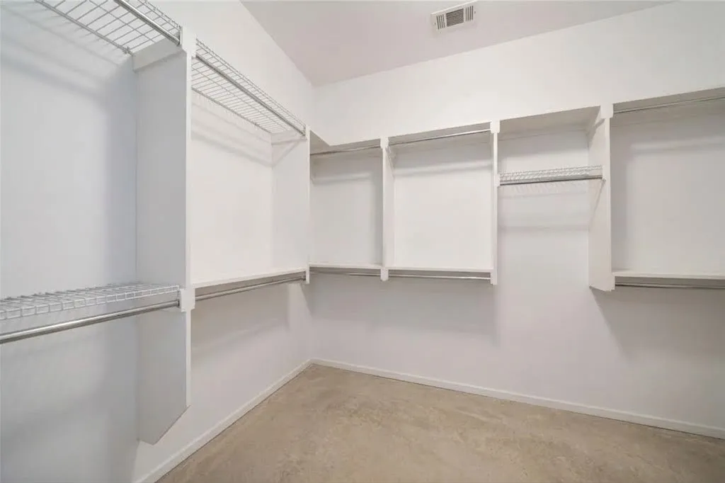 Spacious closet with wire shelving and hanging rods