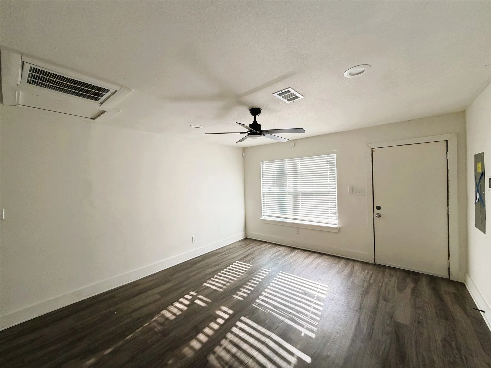 Living room with entry open to kitchen and dining.