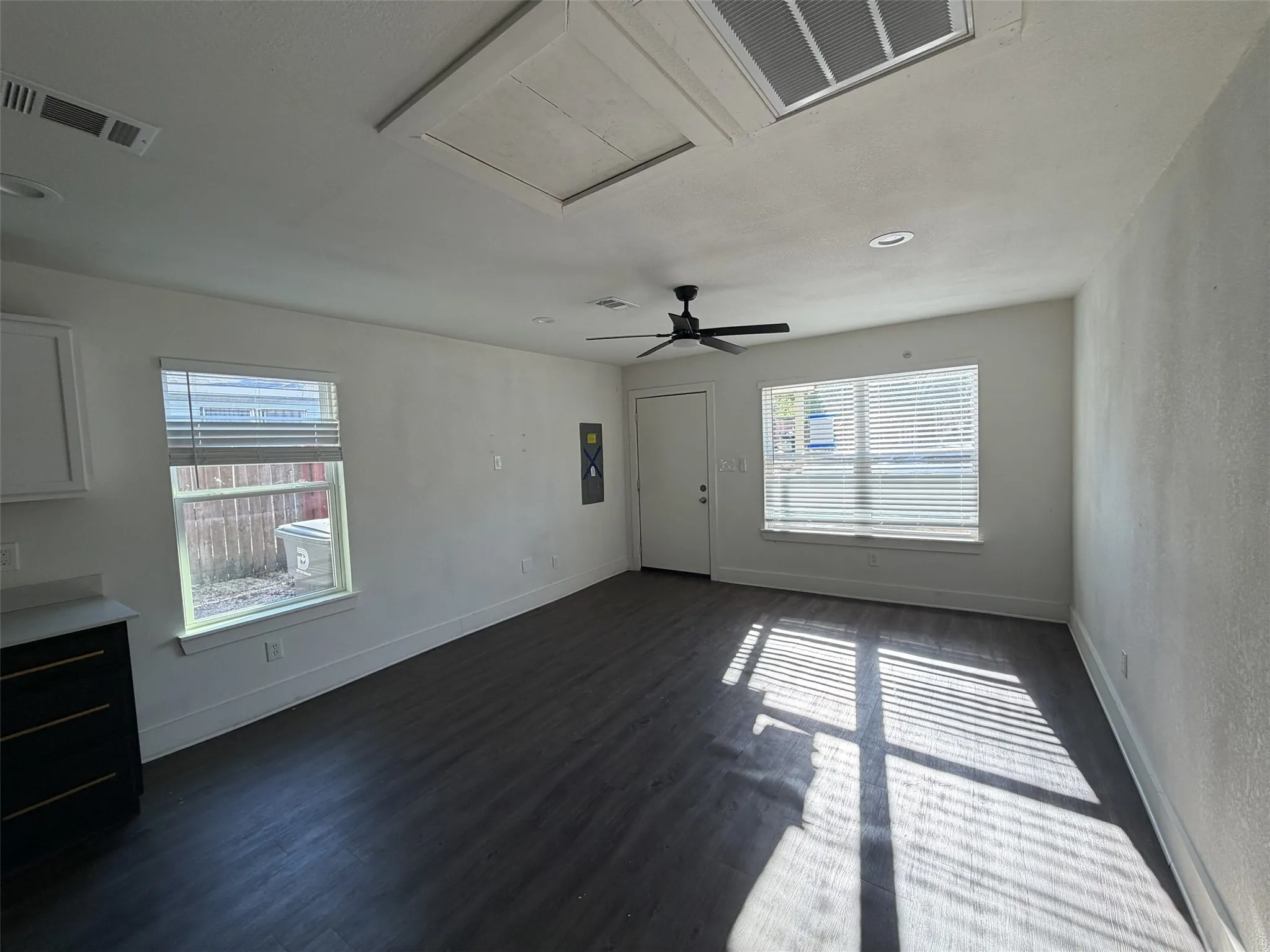 Living room with entry open to kitchen and dining.