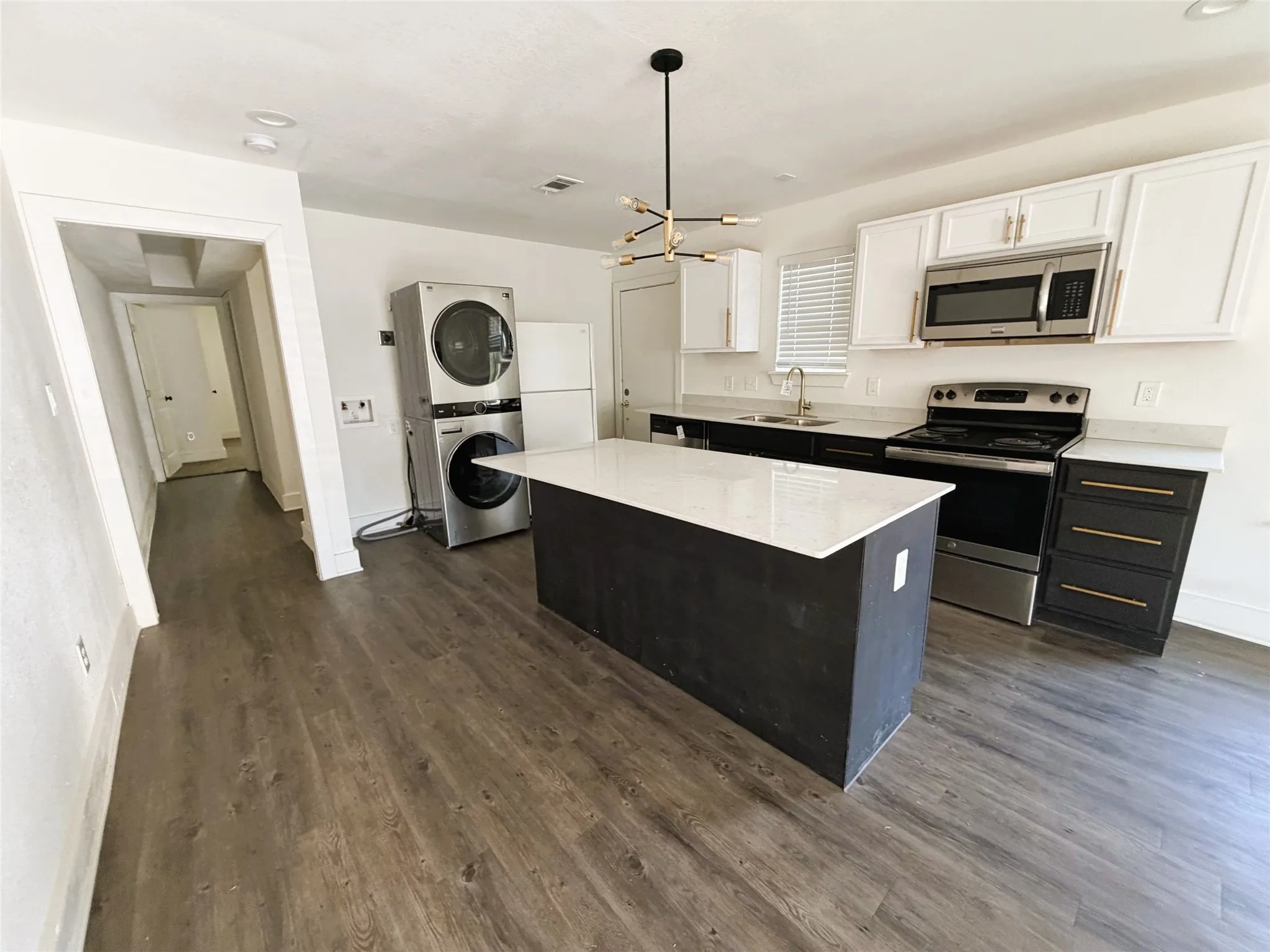 Island with breakfast bar and area of expandable dining table.