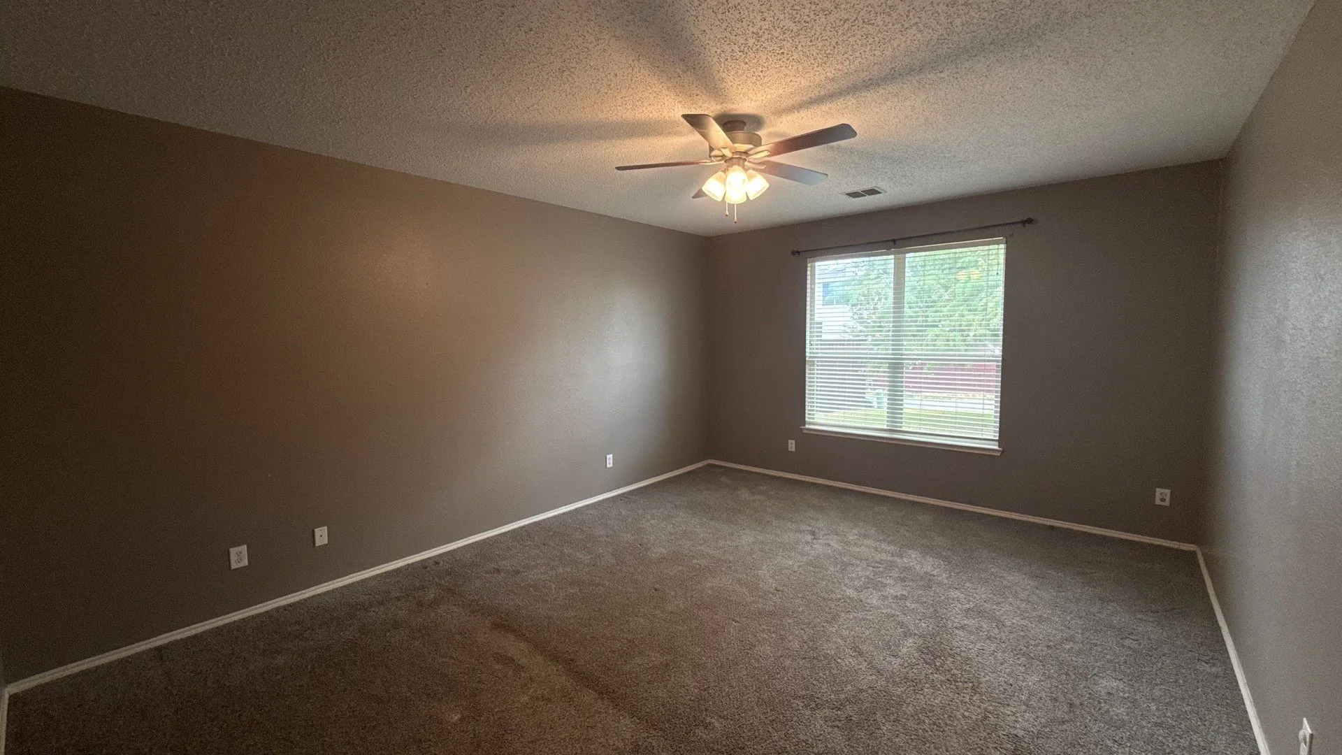 Neutral-toned walls complement the carpeted flooring