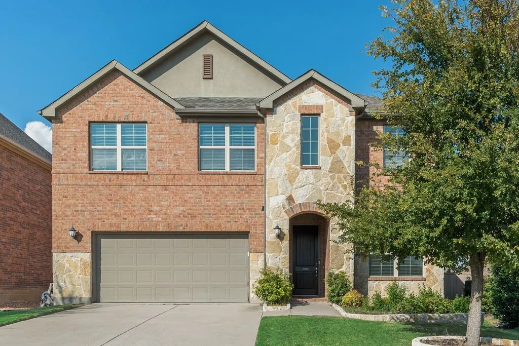 Brick and stone façade with arched entryway