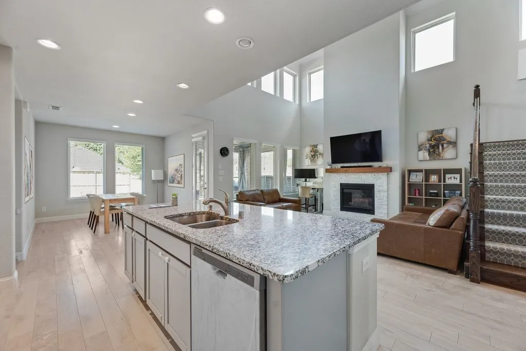 Open-concept living area with light wood-finish flooring