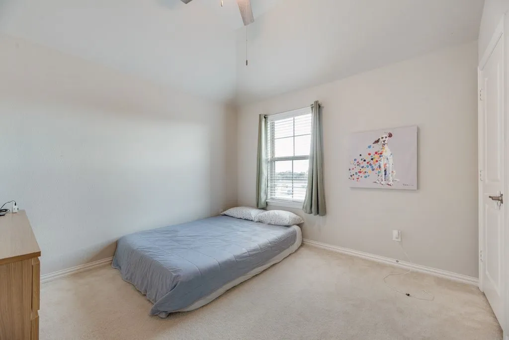 Recessed window with blinds, light-colored carpeting, white wall paint, white trim, and a white paneled door