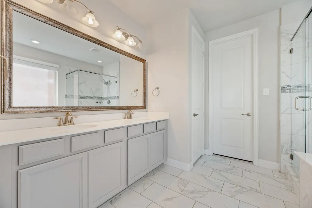 Dual vanity with undermount sinks, quartz countertops, and brushed nickel fixtures