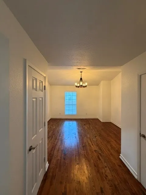 Hardwood flooring throughout, recessed lighting, and a multi-pane window