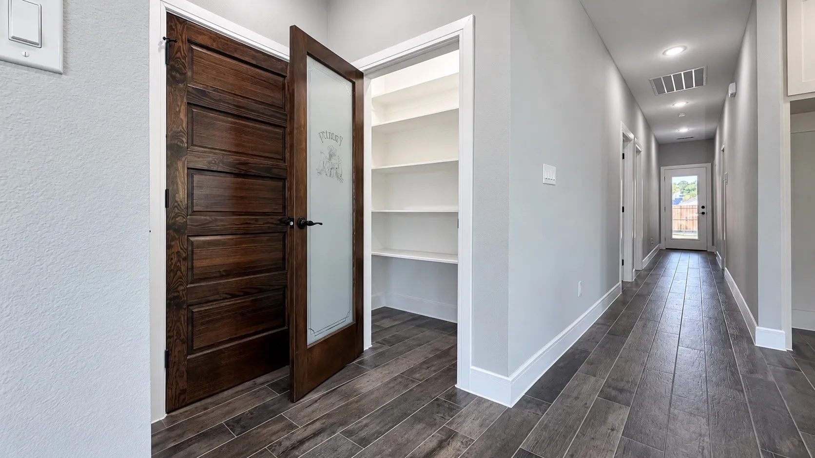 Wood-look plank flooring extending through the hallway
