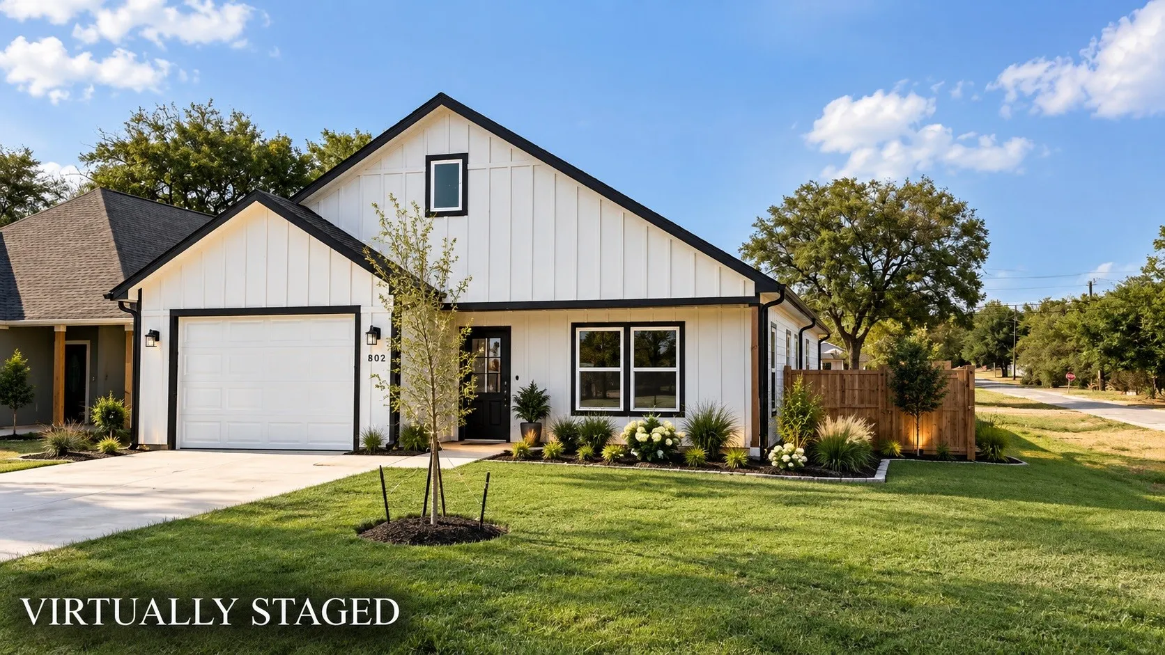 Modern farmhouse exterior with white vertical siding and black trim