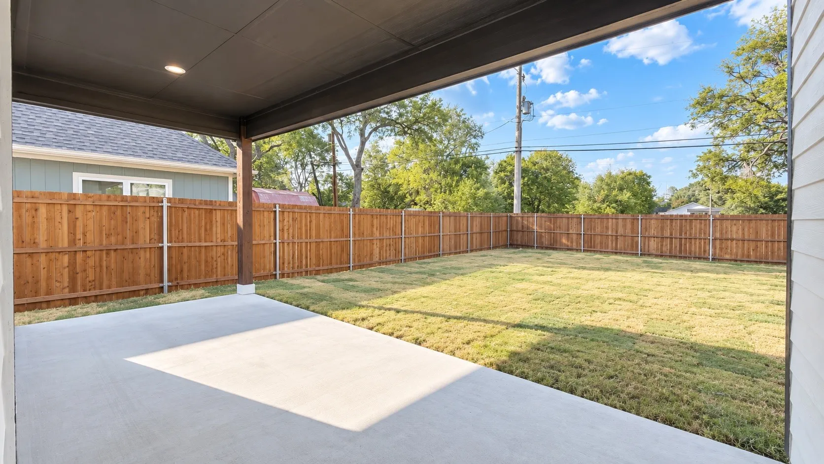 Covered patio with recessed lighting, concrete flooring, and a wooden support beam
