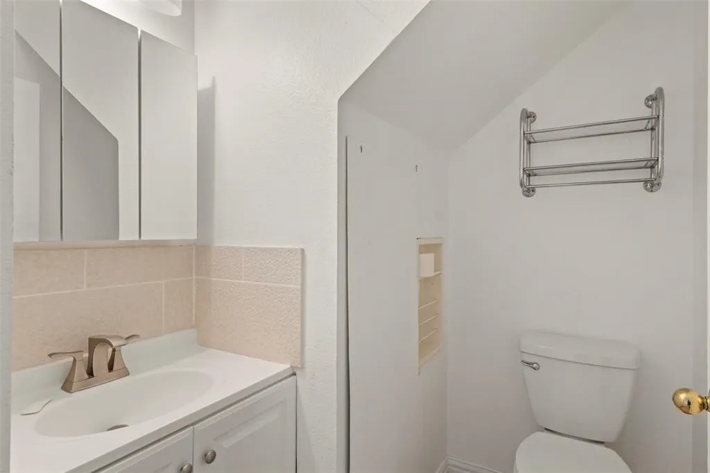 White vanity with an integrated sink and brushed nickel faucet