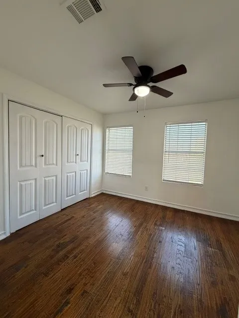 Rich wood-finish flooring complements the crisp white walls