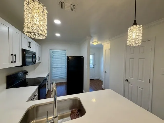 White shaker cabinetry with matte black hardware