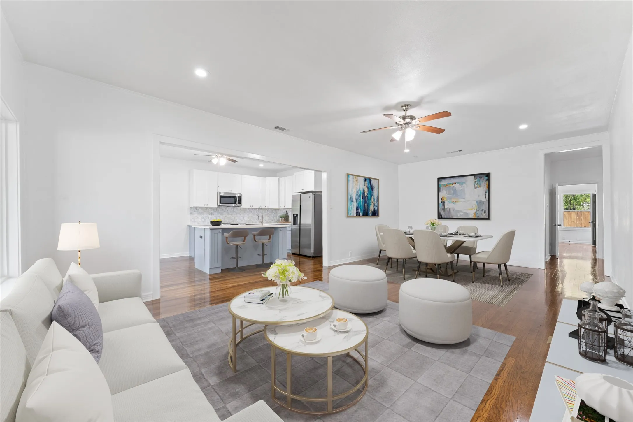 Open concept living area with wood-finish flooring, recessed lighting, and a ceiling fan