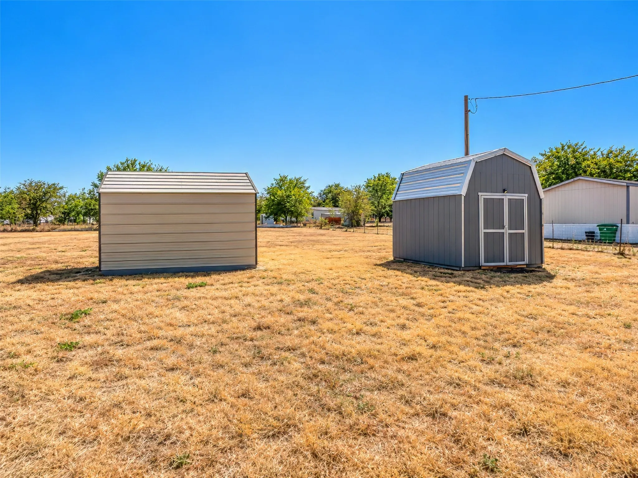 Two detached storage sheds with metal siding and roofs