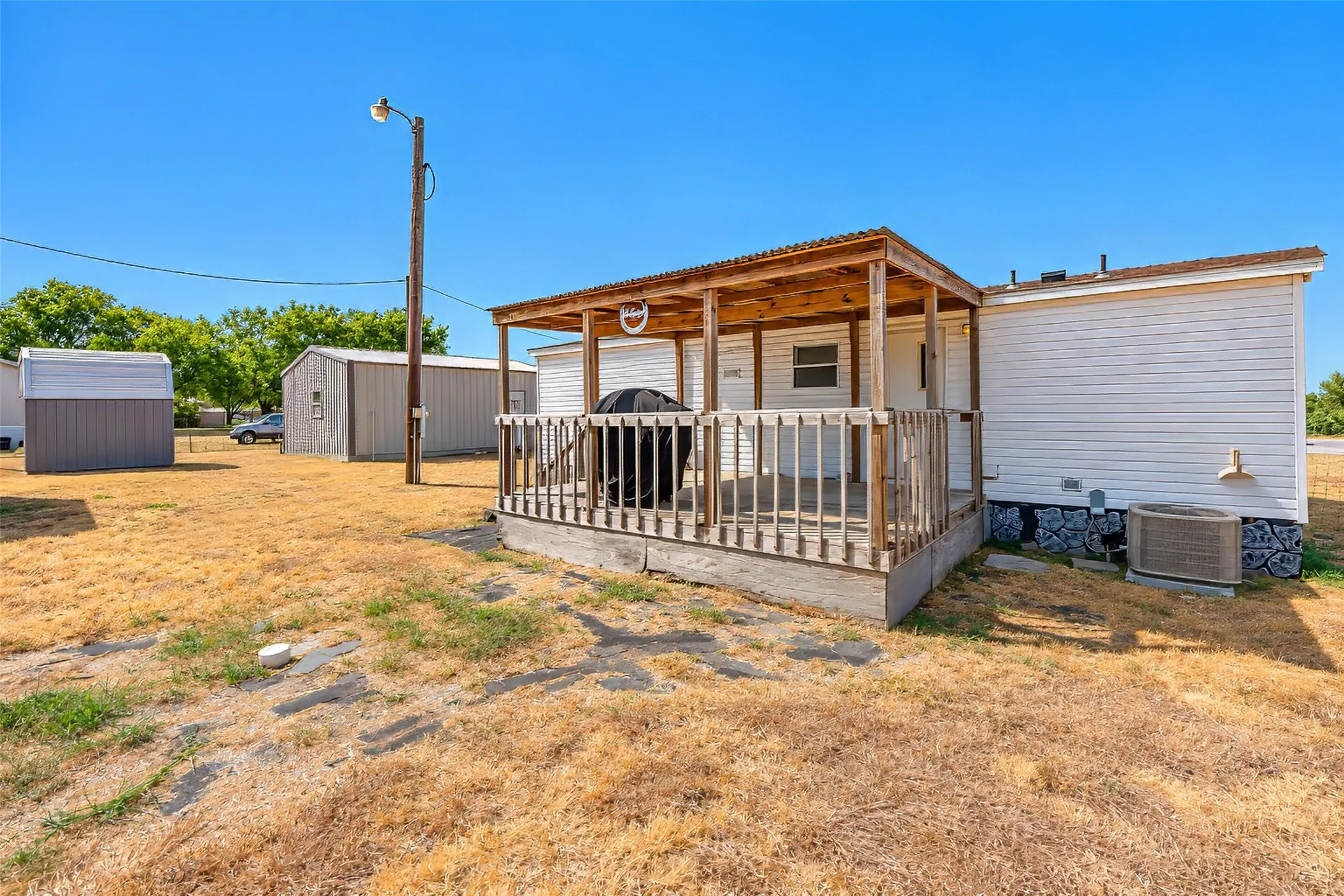 Covered wooden porch with railings
