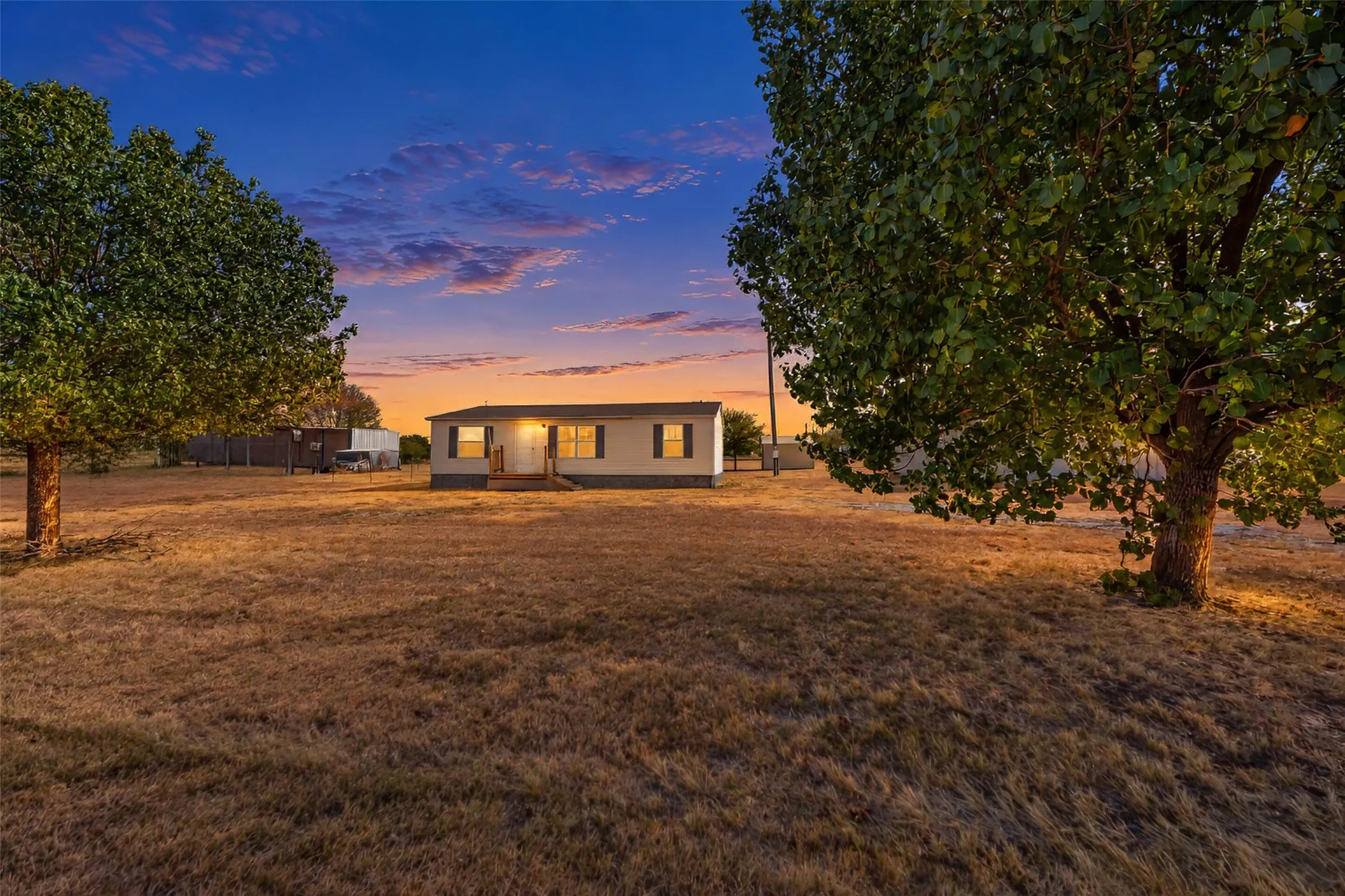 Spacious lot featuring mature trees and a single-story residence with a covered entry