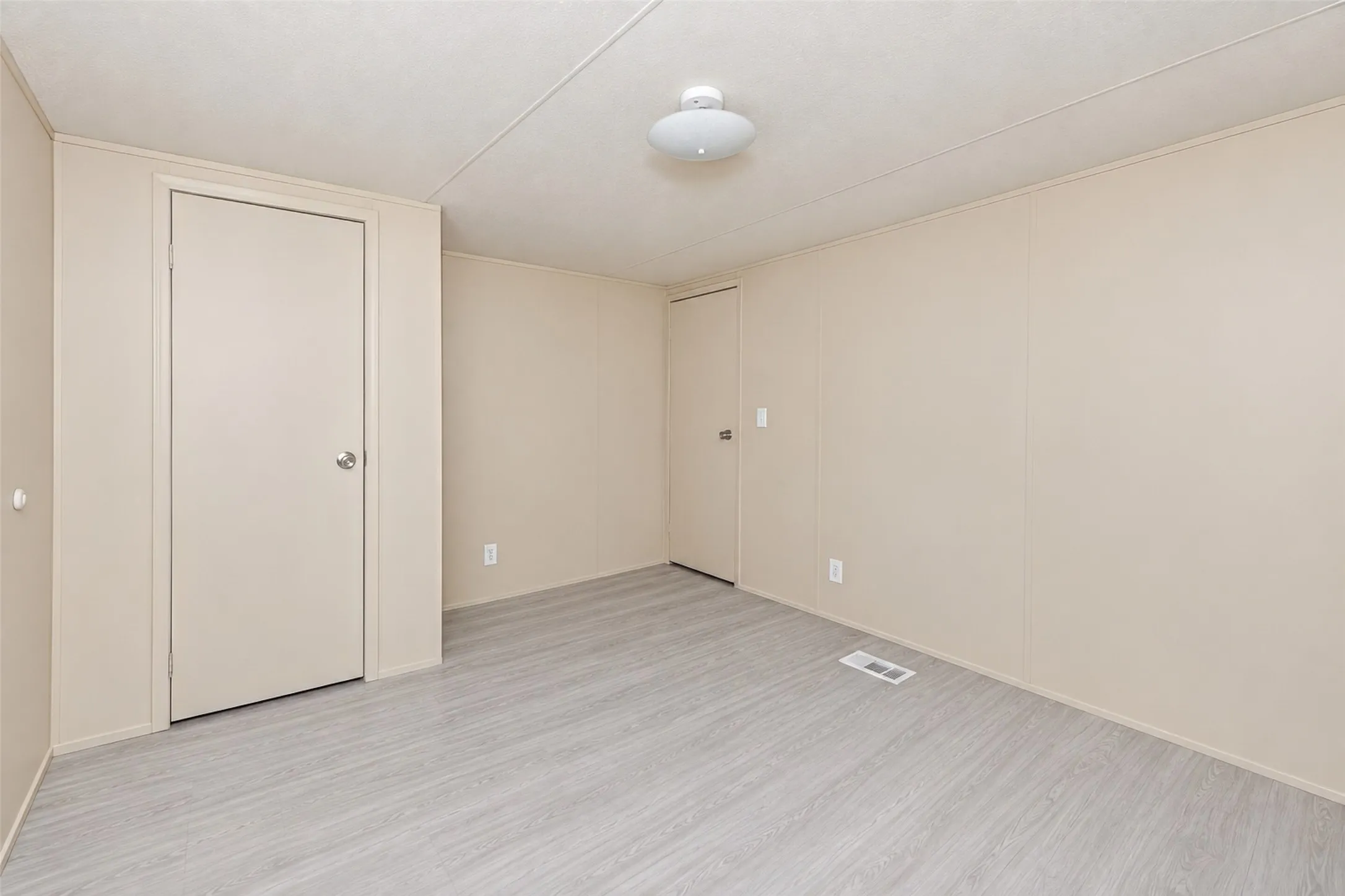 Neutral toned walls complement light wood-finish flooring