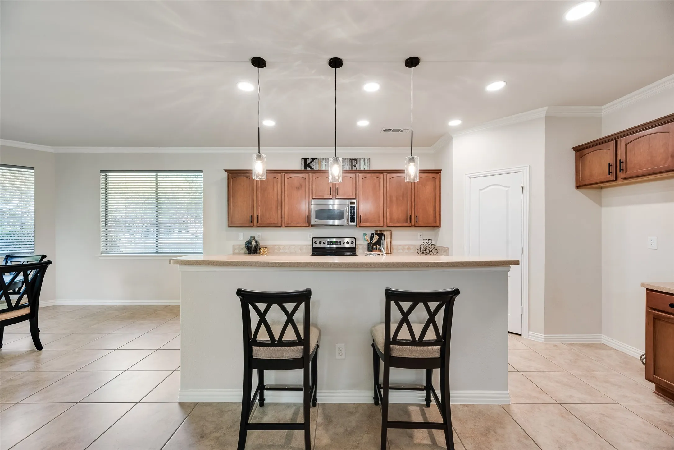 Island with new light fixtures, can lights, walk in pantry