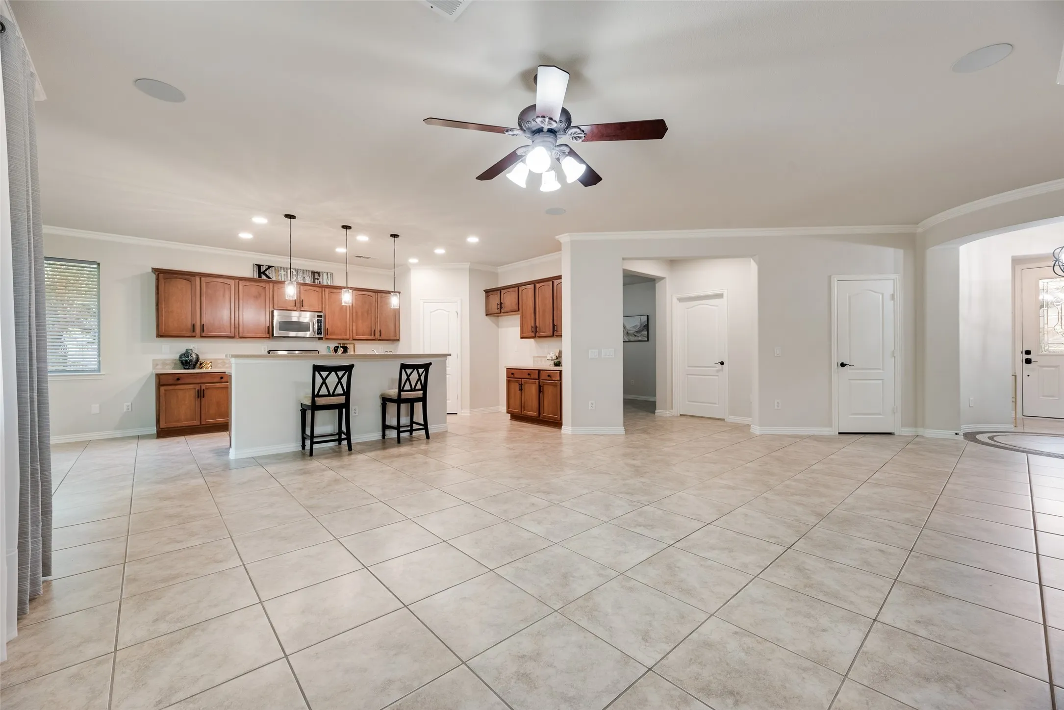 tile floor, crown molding throughout, high ceiling, open concept