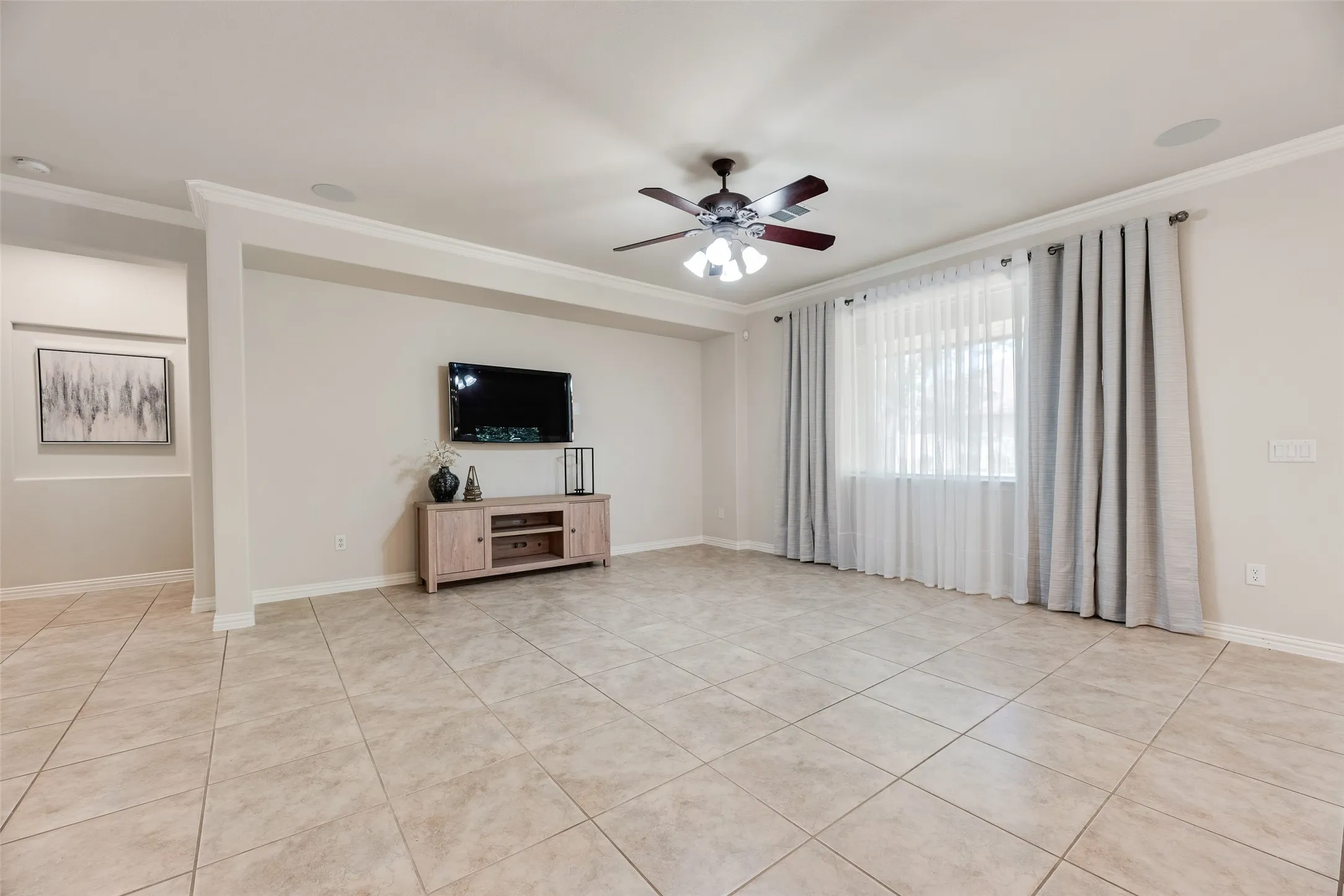 overs size living room, hallway to primary suite, picture windows