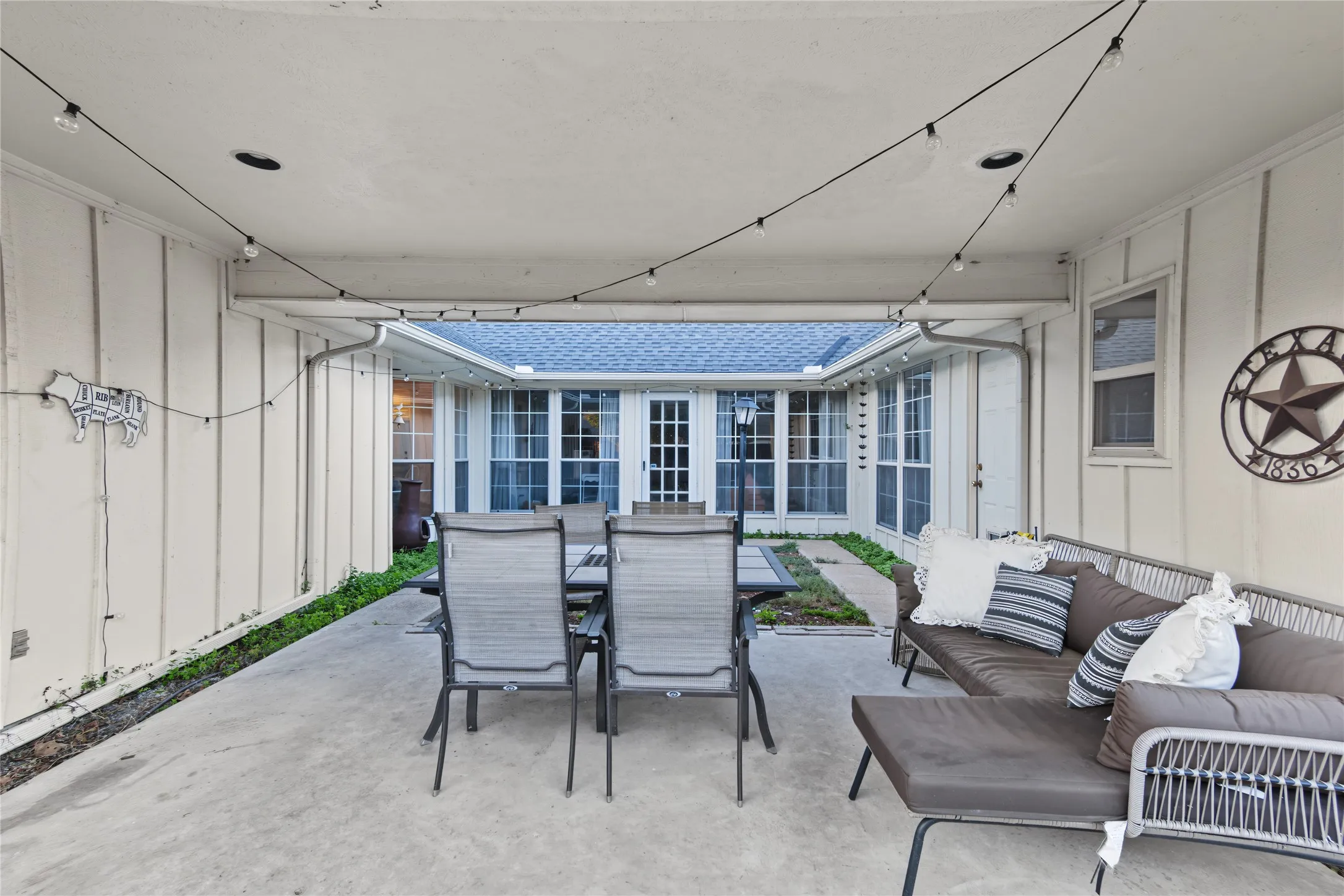 Covered patio with concrete flooring, recessed lighting, and string lighting