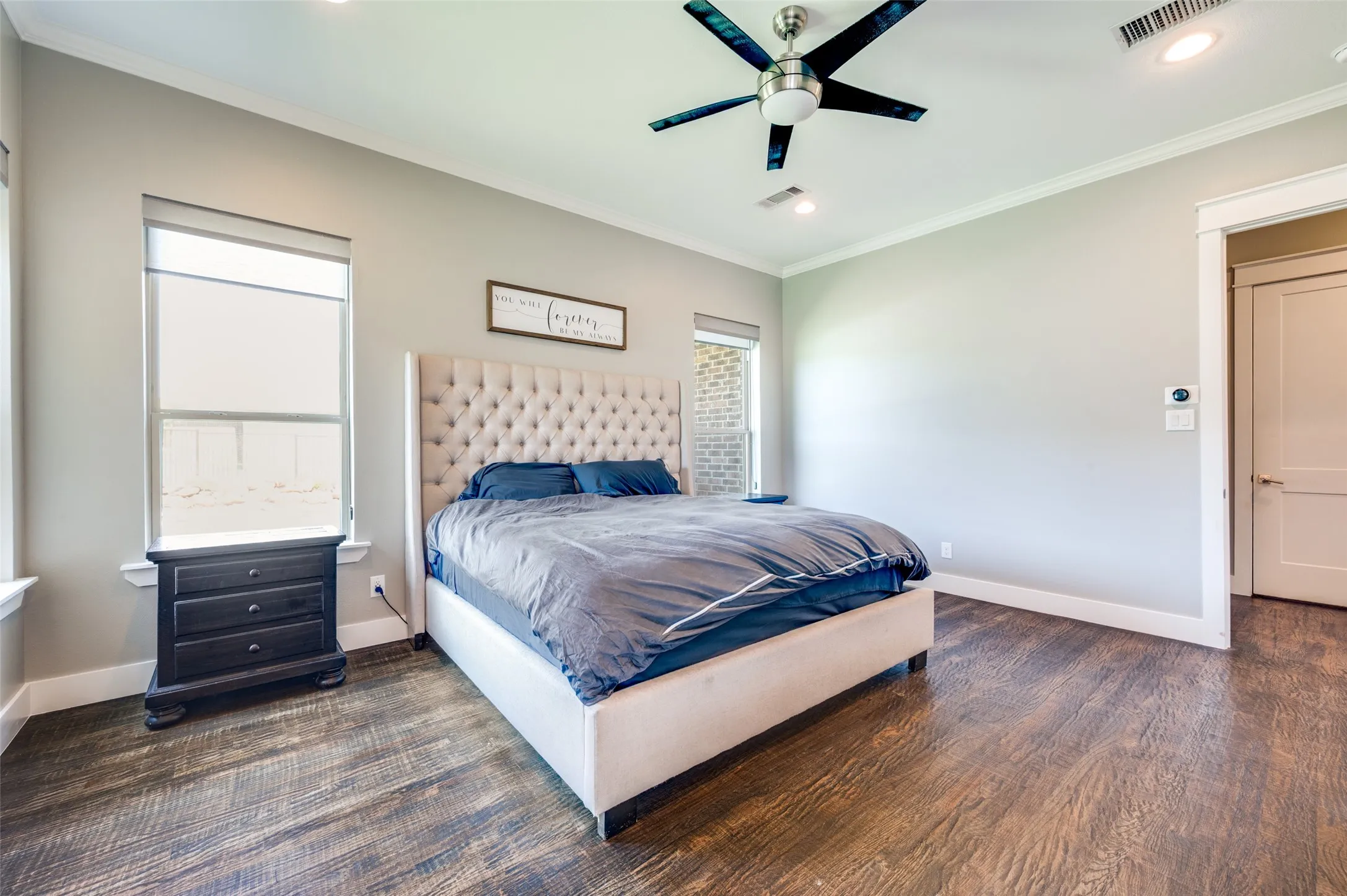 Hardwood-finish flooring, recessed lighting, ceiling fan, crown molding, and a solid core door