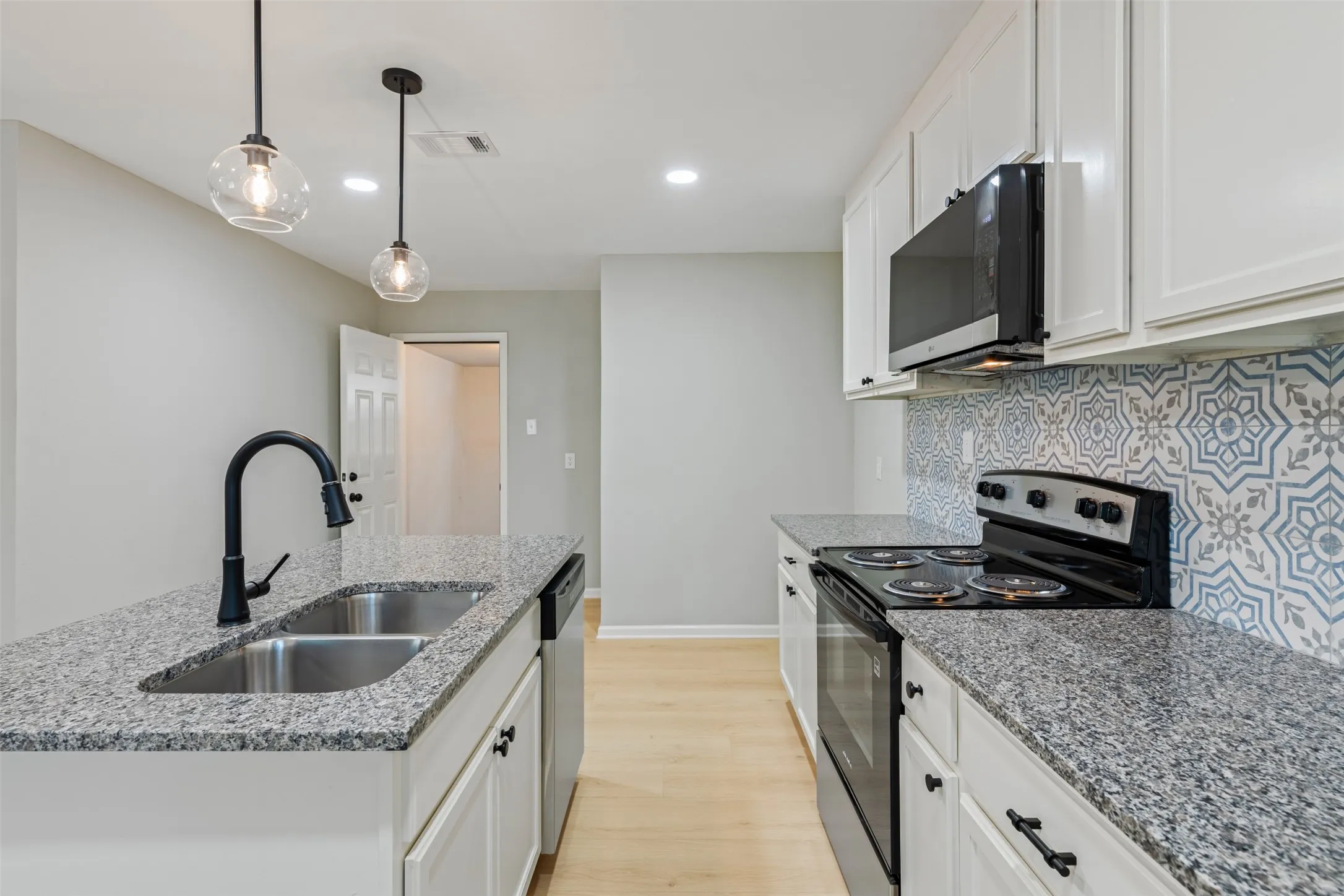 The kitchen has new cabinets, granite coutner tops and back splash