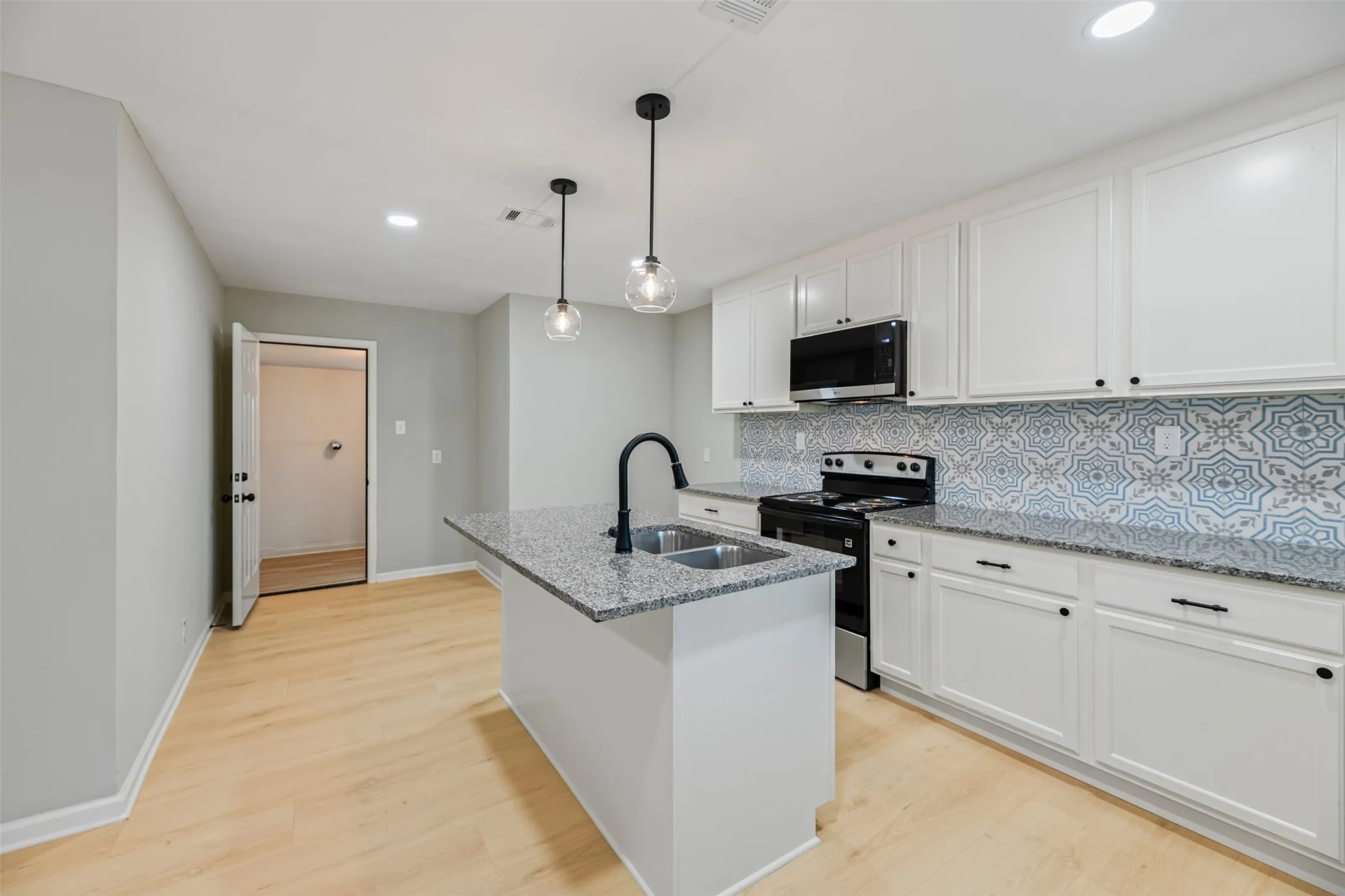 The kitchen island has a breakfast bar top providing a great place for quick meals