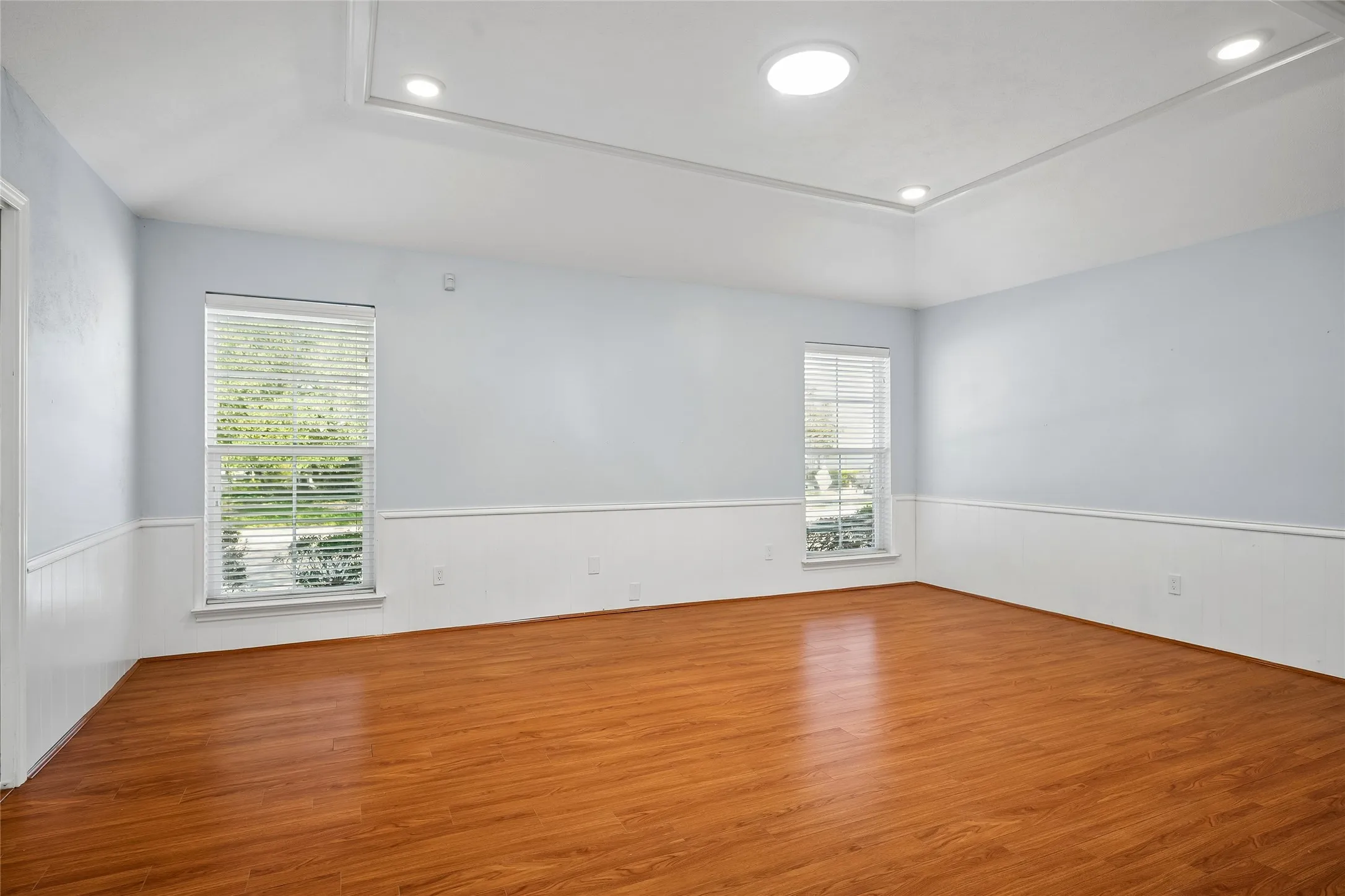 Spacious family room has a pocket door opening  to the kitchen.  Solar tubes are in both living areas, the hall, and bathrooms.
