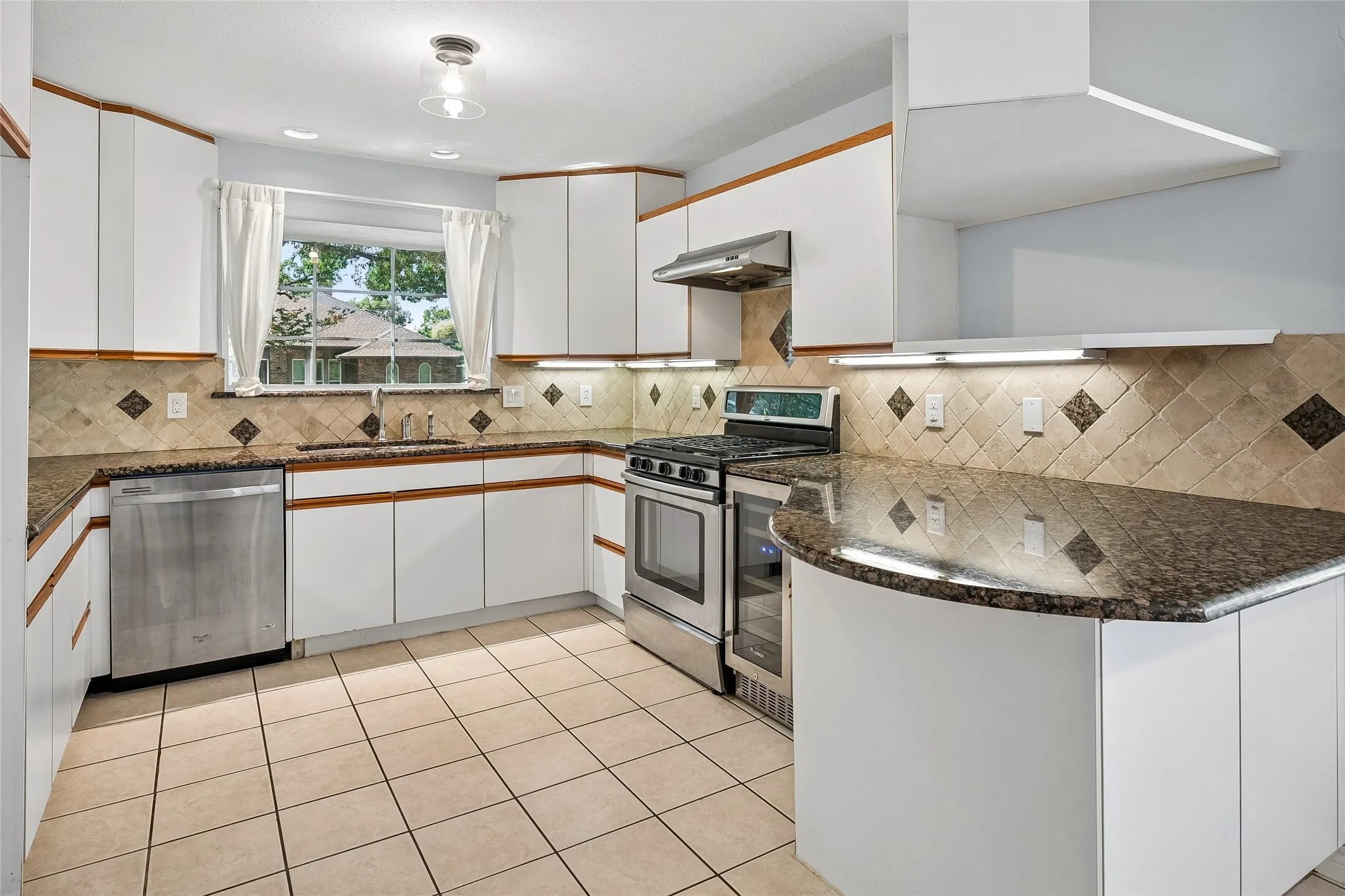 Updated cabinets and a charming window box over the sink