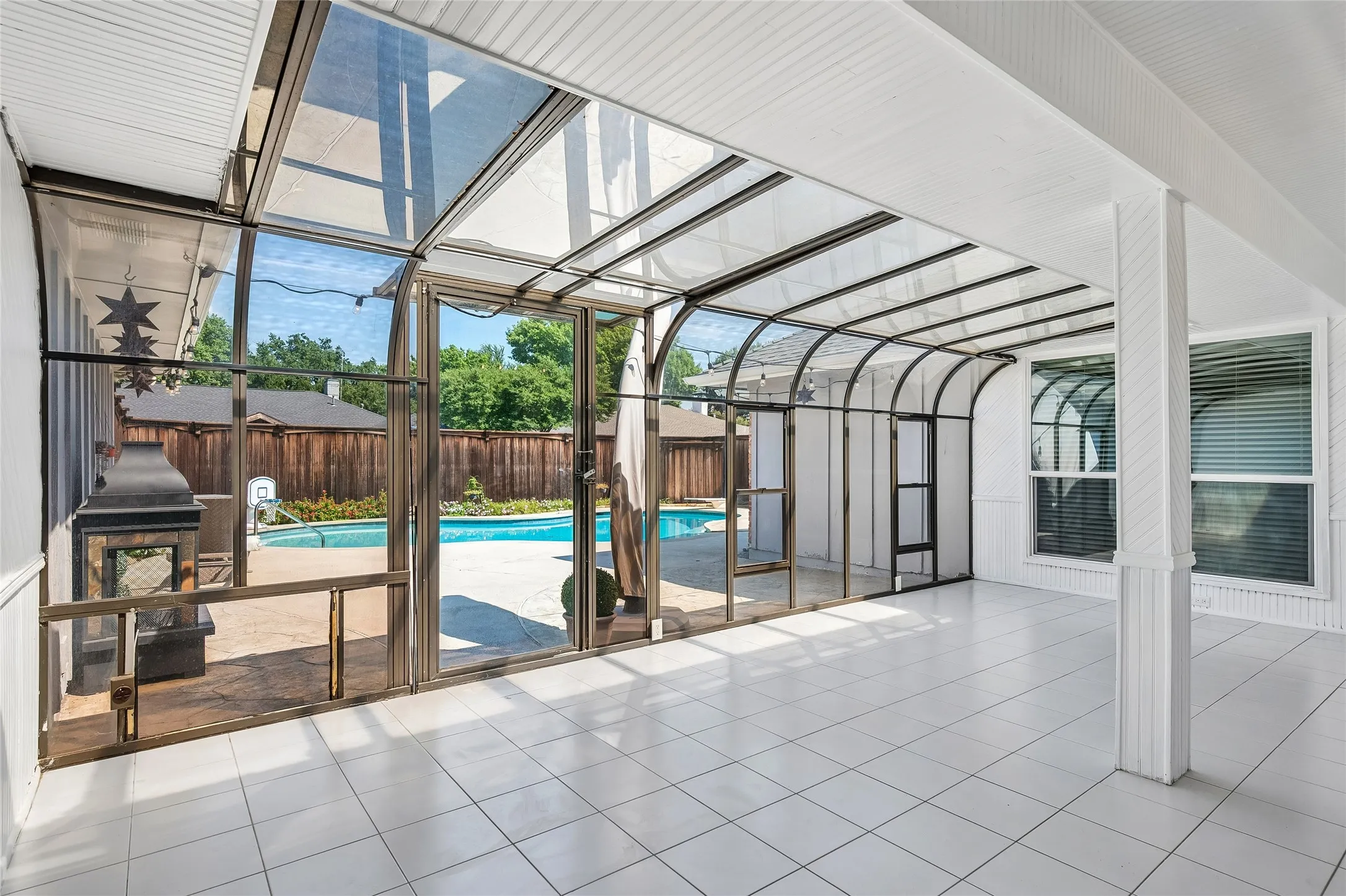 Enjoy entertaining in the bright sunroom opening to the backyard