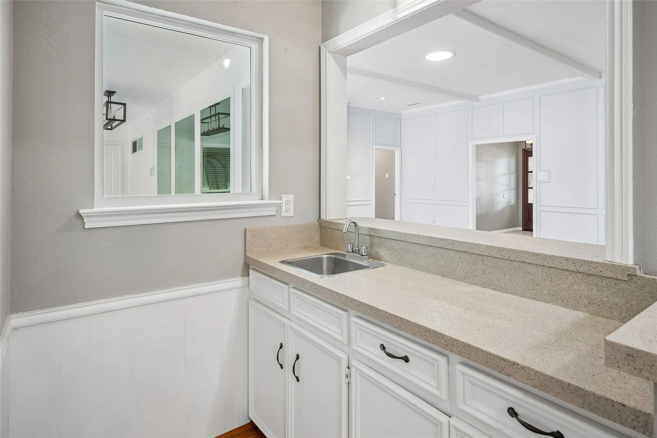 The wet bar can be entered from the family room and it serves both living areas.